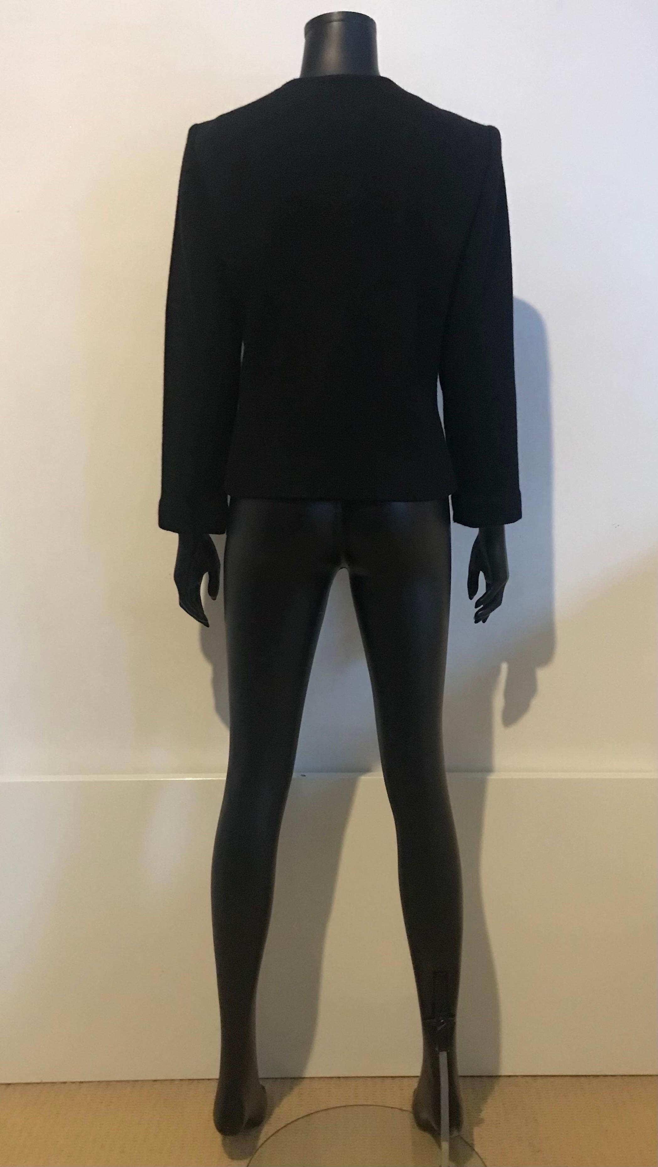 This beautiful vintage piece from an exciting era of Yves Saint Laurent Rive Gauche is a black brocade and ribbed knit evening jacket 

Flattering shape and classic YSL cut with oversized front button fastening detail 

From the mid 1970’s 

Fully