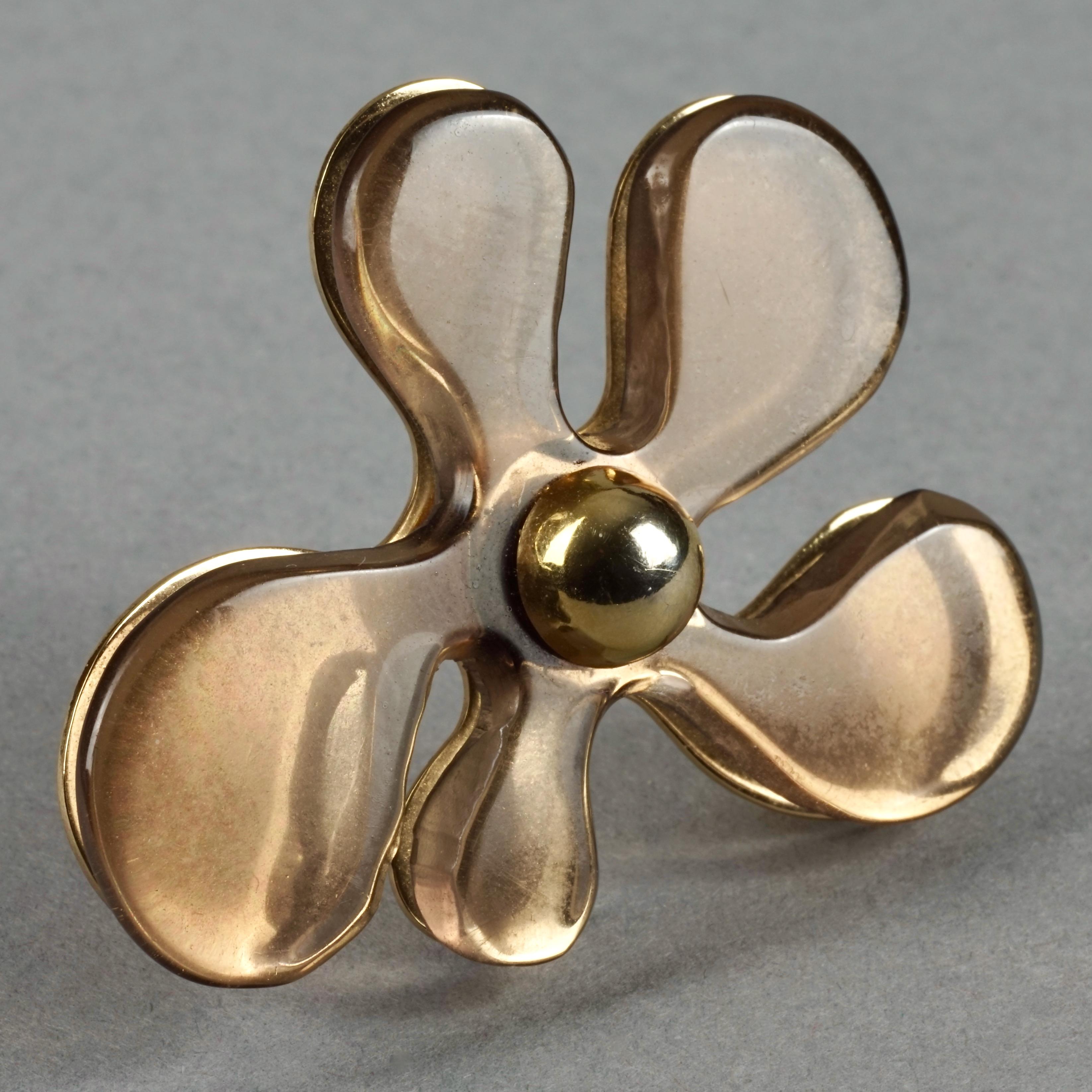 Vintage 1971 CHRISTIAN DIOR Lucite Flower Brooch

Measurements:
Height: 2.28 inches (5.8 cm) 
Width: 1.89 inches (4.8 cm)

Features:
- 100% Authentic CHRISTIAN DIOR.
- Lucite plexiglas flower in brown color.
- Gold tone hardware.
- Signed CHR DIOR