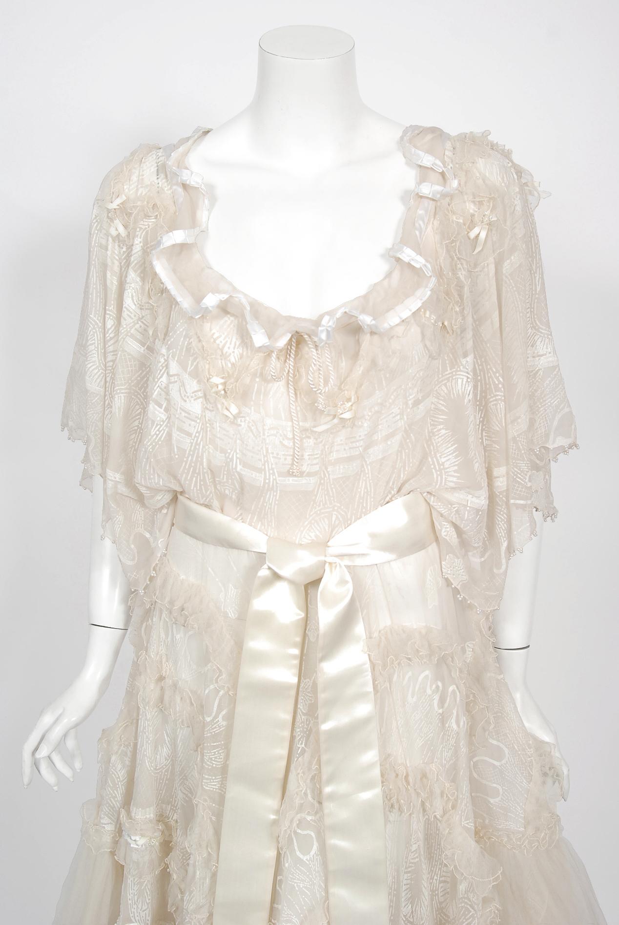 An ethereal and truly iconic Zandra Rhodes hand-painted sheer silk chiffon & tiered tulle ivory bridal gown dating back to her 1973 'Shells' couture collection. As shown, a similar version was Princess Anne's choice look for her official 1973