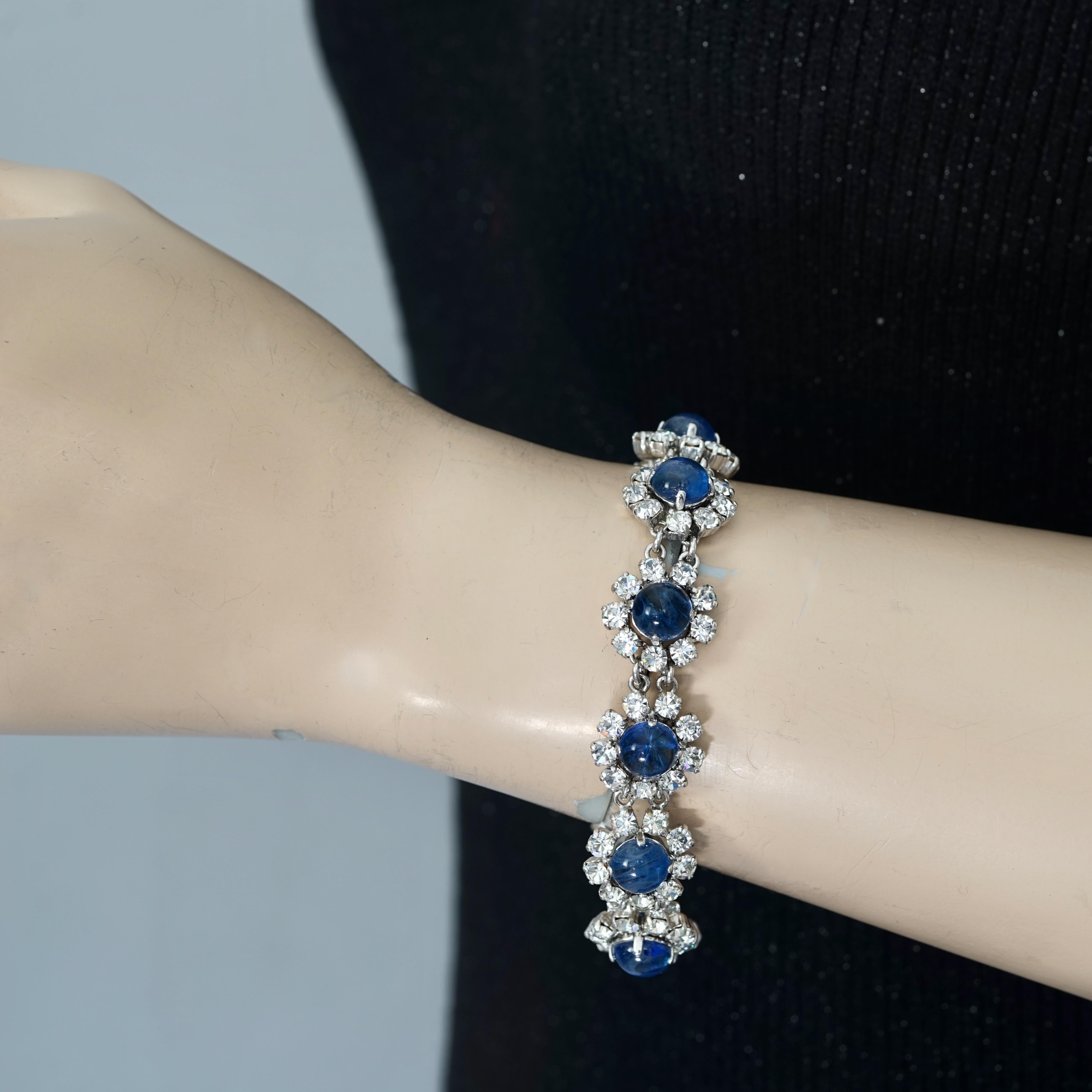 Vintage 1973 CHRISTIAN DIOR Blue Glass Cabochon Rhinestone Bracelet

Measurements:
Height: 0.63 inch (1.6 cm)
Wearable Length: 7.28 inches (18.5 cm)

Features:
- 100% Authentic CHRISTIAN DIOR.
- Blue round glass cabochon with rhinestones link