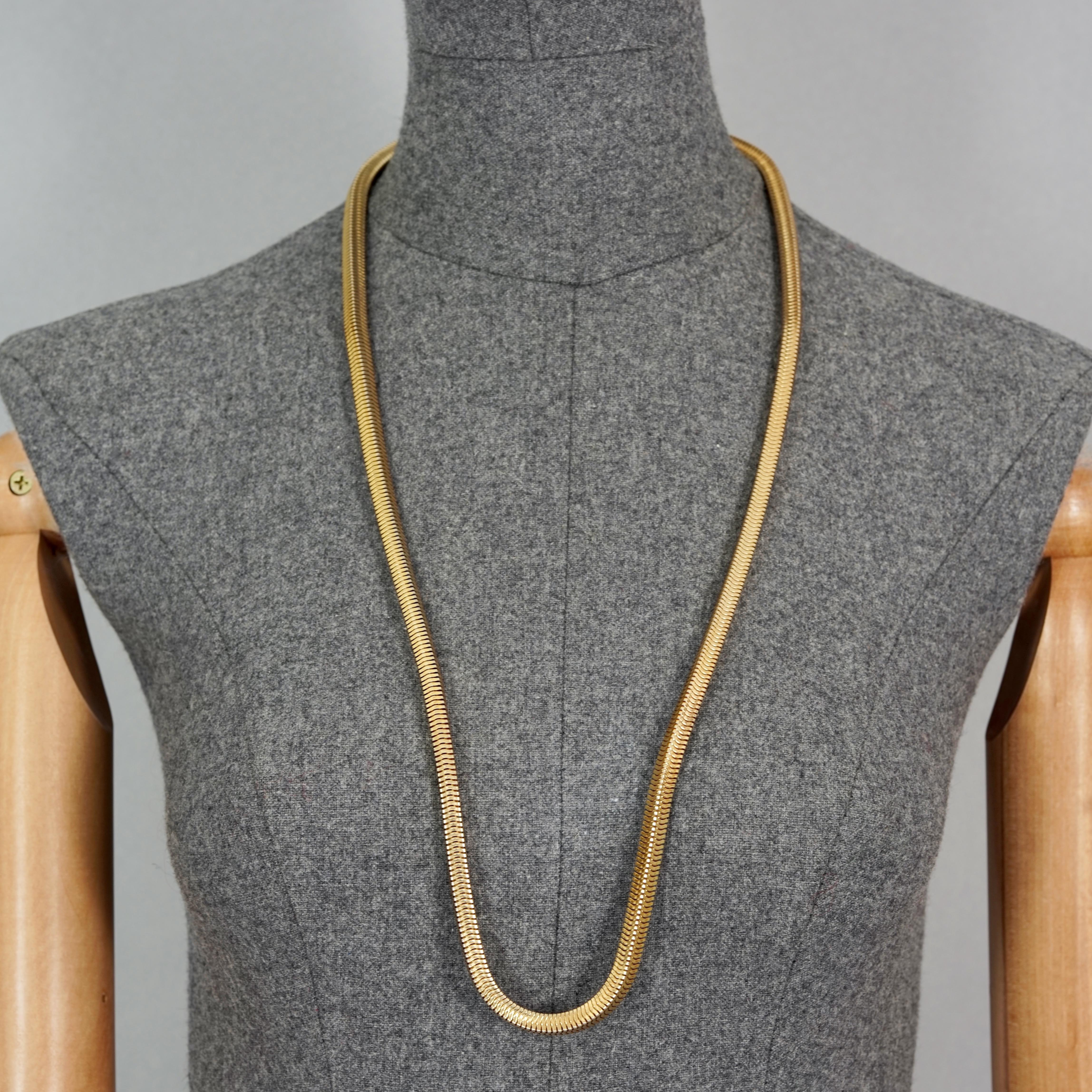 Vintage 1973 CHRISTIAN DIOR Gold Snake Chain Necklace

Measurements:
Height: 0.23 inch (0.6 cm)
Wearable Length: 32.28 inches (82 cm)

Features:
- 100% Authentic CHRISTIAN DIOR.
- Long snake chain necklace.
- Gold tone hardware.
- Signed 1973 CHR