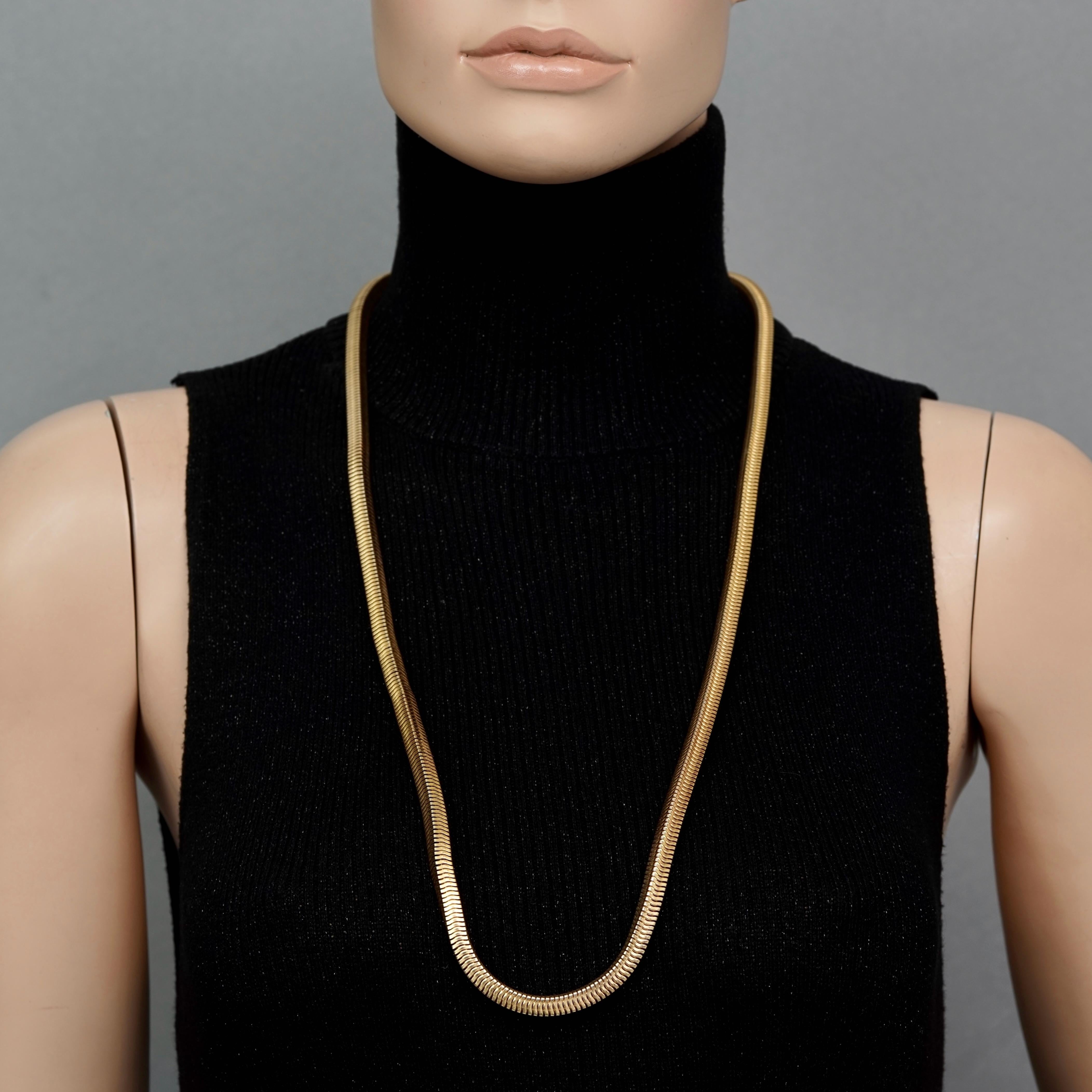 Vintage 1973 CHRISTIAN DIOR Gold Snake Chain Necklace

Measurements:
Height: 0.23 inch (0.6 cm)
Wearable Length: 32.28 inches (82 cm)

Features:
- 100% Authentic CHRISTIAN DIOR.
- Long snake chain necklace.
- Gold tone hardware.
- Signed 1973 CHR