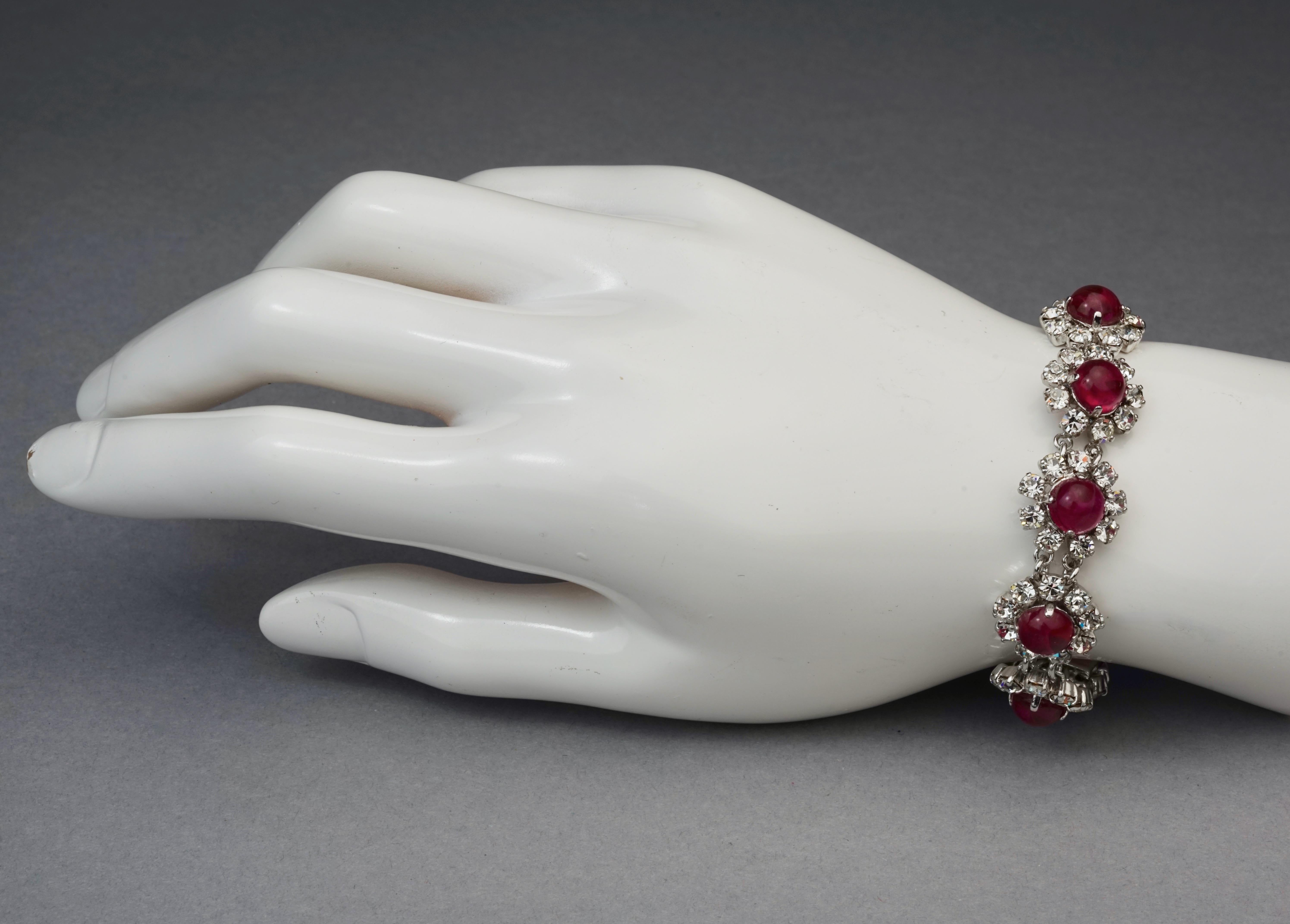 Vintage 1973 CHRISTIAN DIOR Red Glass Cabochon Rhinestone Bracelet

Measurements:
Height: 0.63 inch (1.6 cm)
Wearable Length: 7.08 inches (18 cm)

Features:
- 100% Authentic CHRISTIAN DIOR.
- Red round glass cabochon with rhinestones link