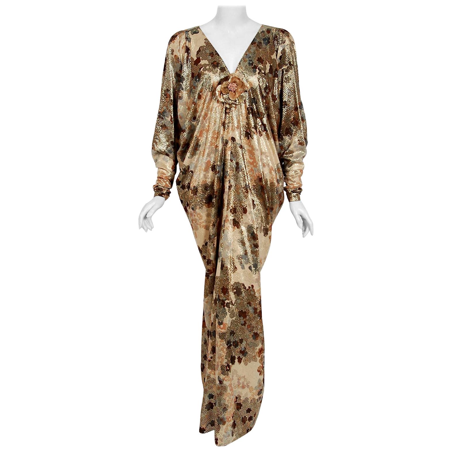 Breathtaking Yves Saint Laurent Haute-Couture documented caftan gown fashioned in a the most beautiful light-weight metallic print golden lamé silk. A similar version was featured on the cover of Elle France magazine September 1975. The fabric is