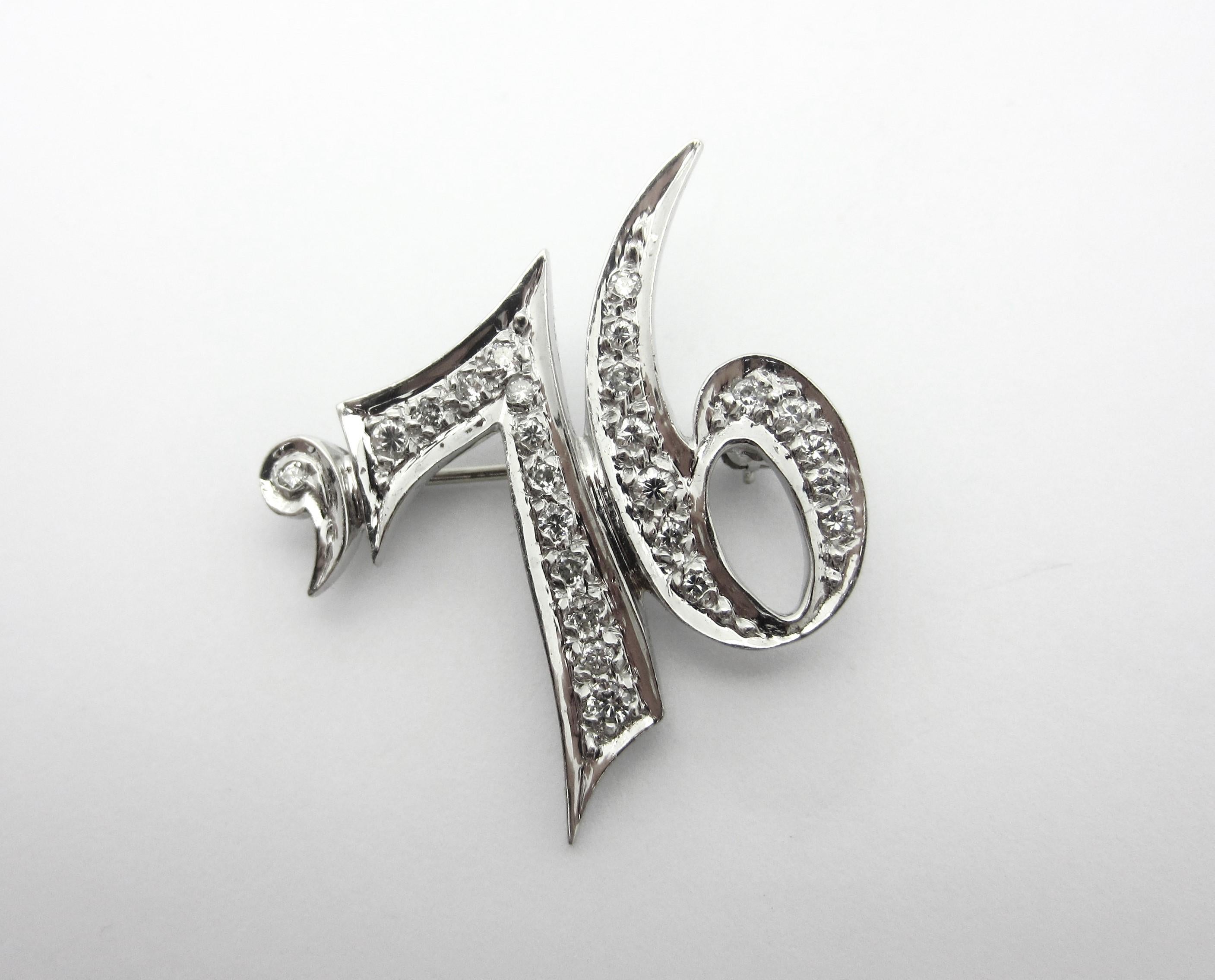 This beautiful vintage convertible pendant/brooch was crafted from 14k white gold in the 1970s.  The piece reads 