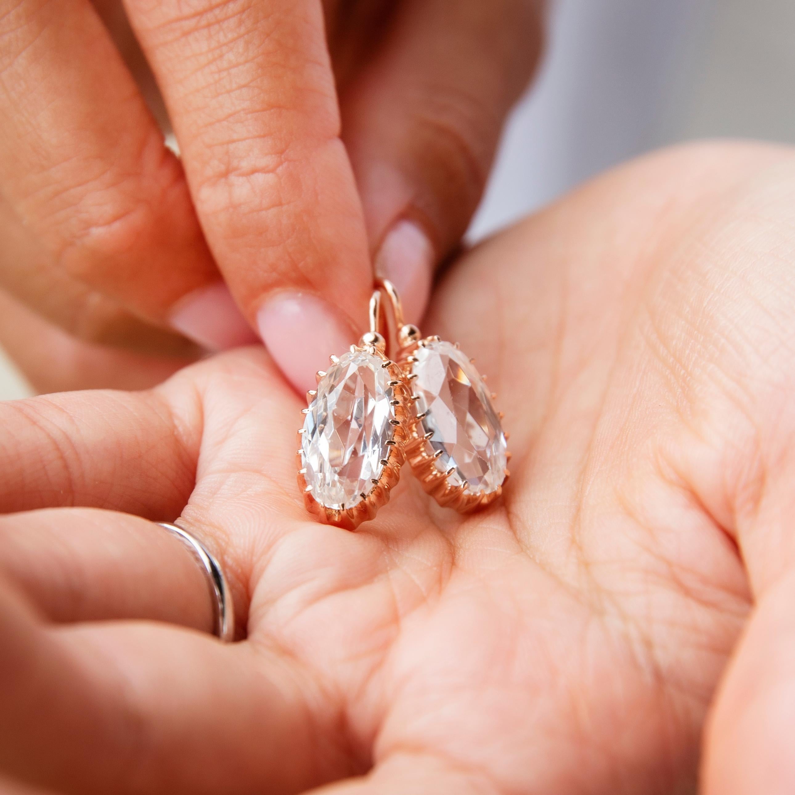 Crafted with love in 14 carat gold, these wonderfully choice Russian drop earrings, made in 1977, are each a captivating oval faceted white crystal glass in a charming rose gold setting and finished with lever hook backings. They have been named The