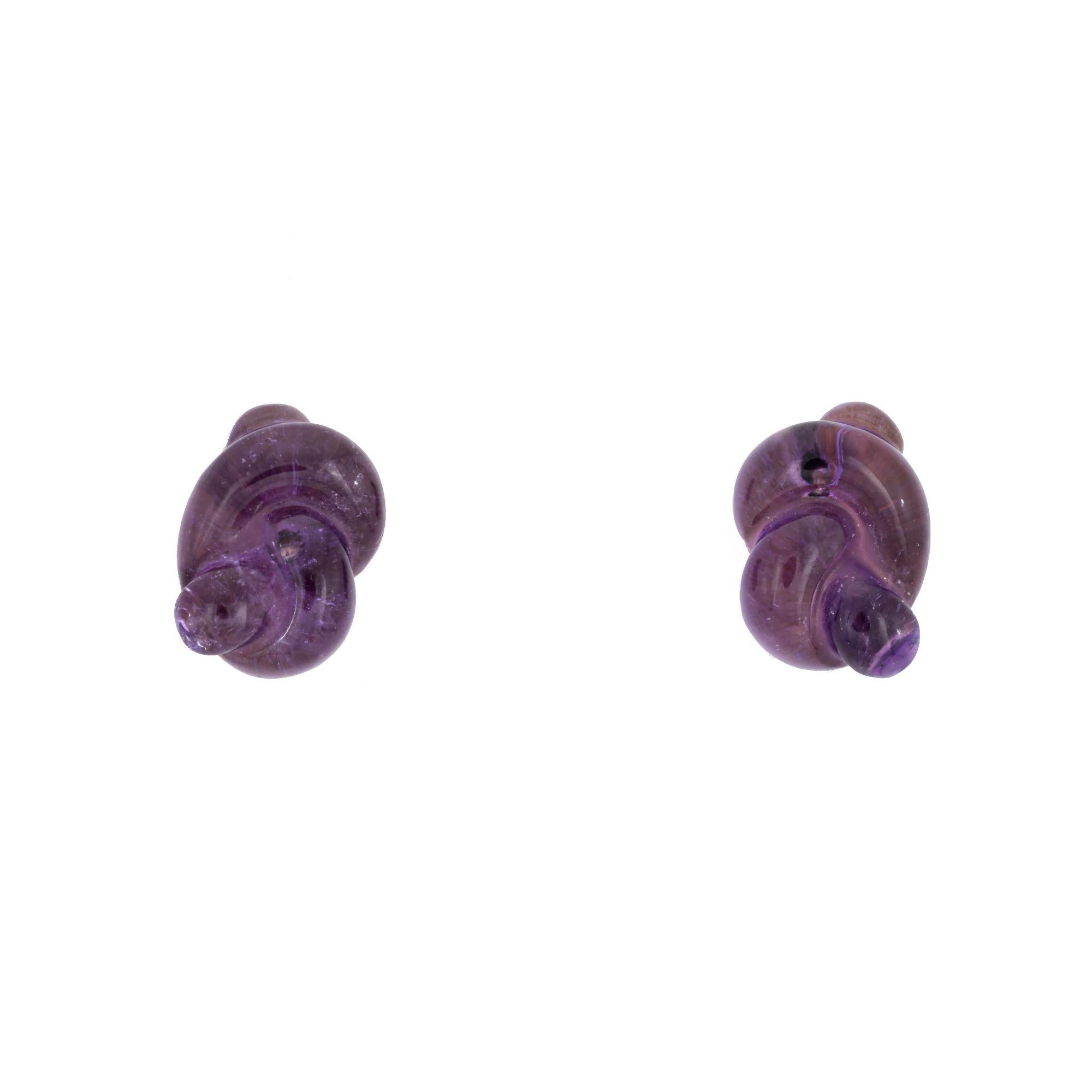 Finely detailed pair of vintage Tiffany & Co amethyst infinity knot earrings (circa 1979) crafted in 18k yellow gold. 

Amethysts measure 11mm x 7.5mm (in very good condition and free of cracks or chips).

Dating to 1979 the earrings are set with