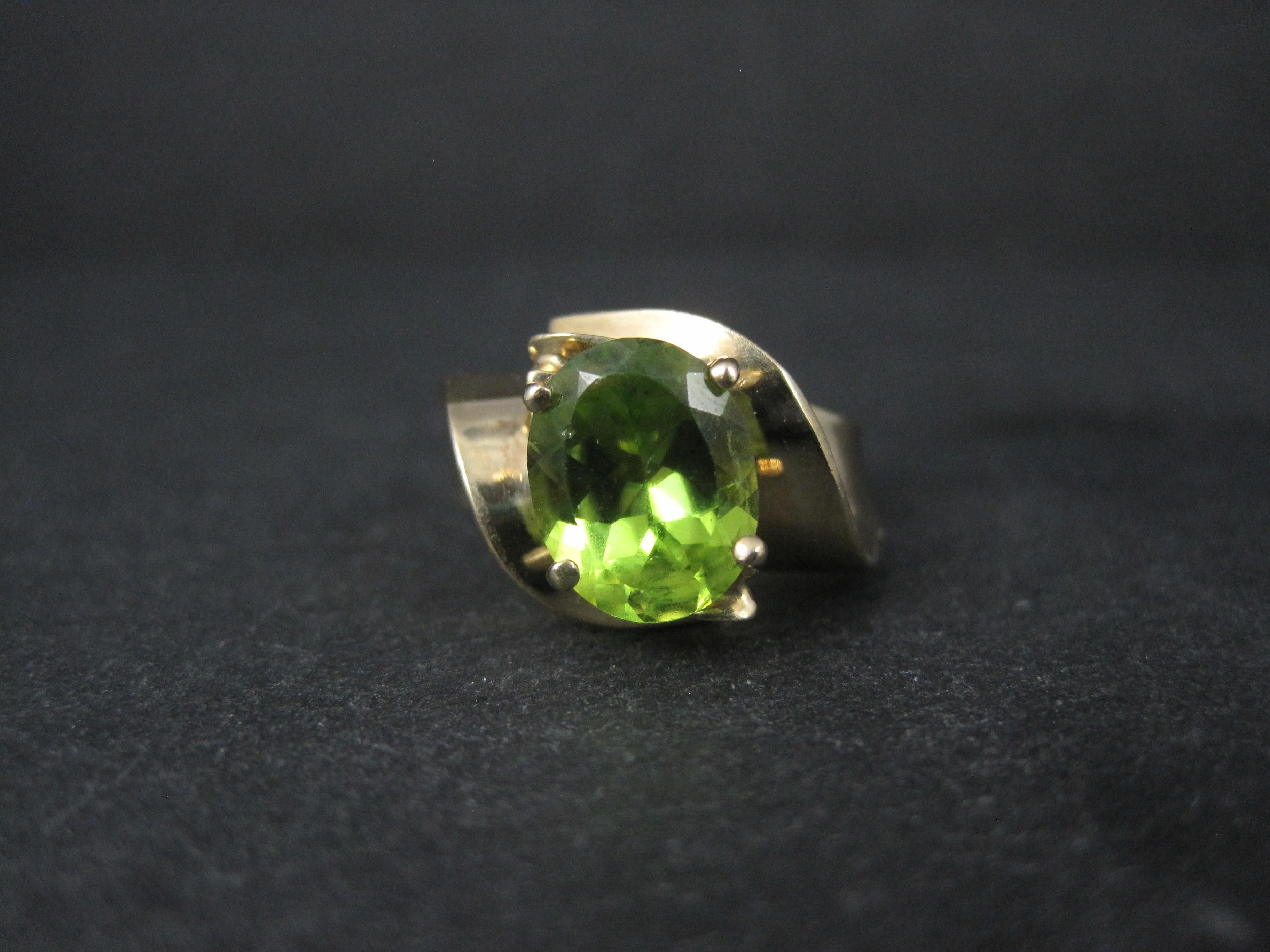 Dieser schöne Ring aus den 1980er Jahren ist aus 10k Gelbgold.
Er ist mit einem oval geschliffenen, 8x10 mm großen Peridot-Edelstein besetzt.
Die Vorderseite dieses Rings misst 1/2 Zoll von Norden nach Süden mit einem Anstieg von 7 mm über den