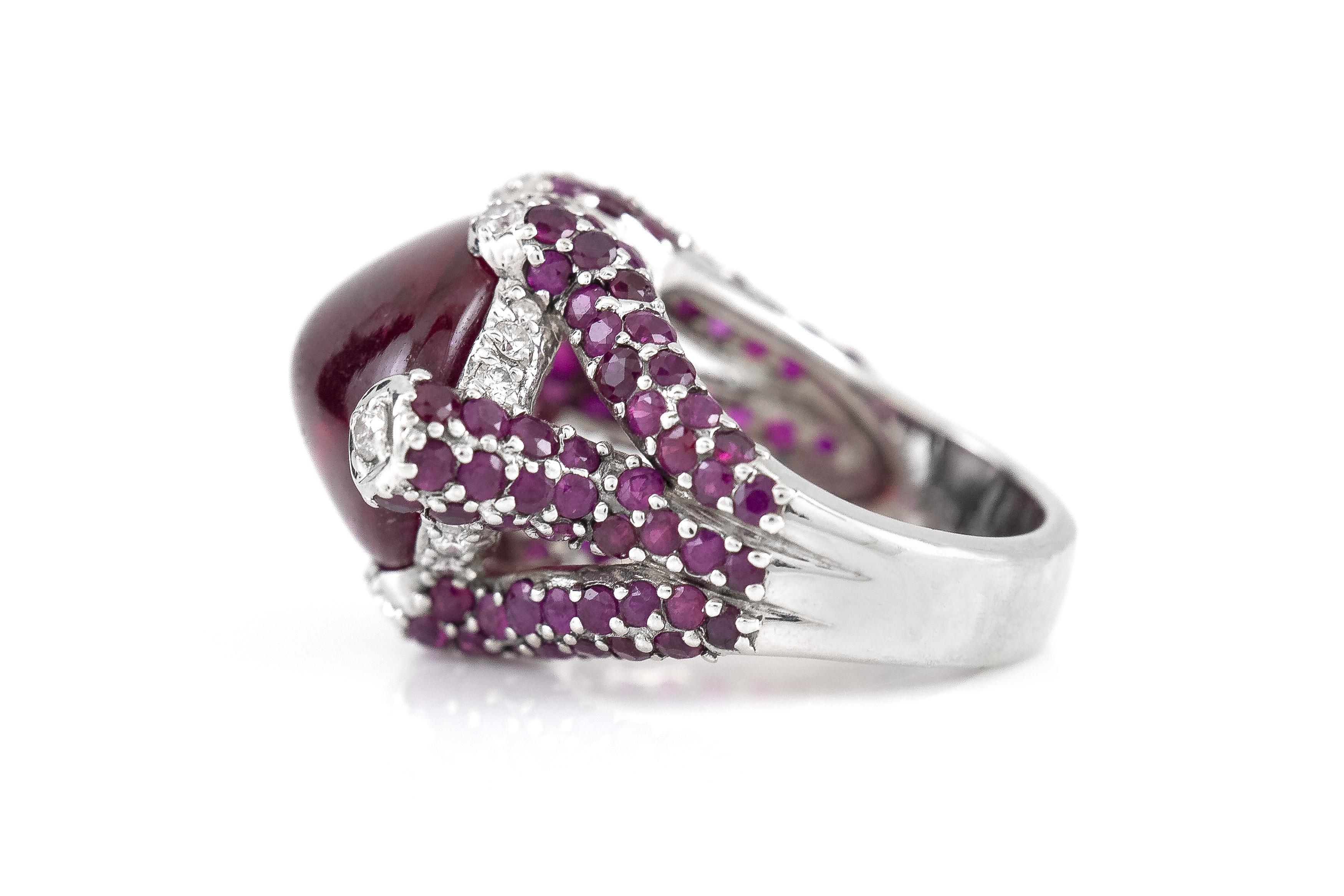 Finely crafted in 18k white gold with a Cabochon Rubellite weighing approximately 12.00 carats, Round cut Rubies weighing approximately a total of 2.00 carats, and Round Brilliant cut Diamonds weighing approximately a total of 0.20 carat.
Circa