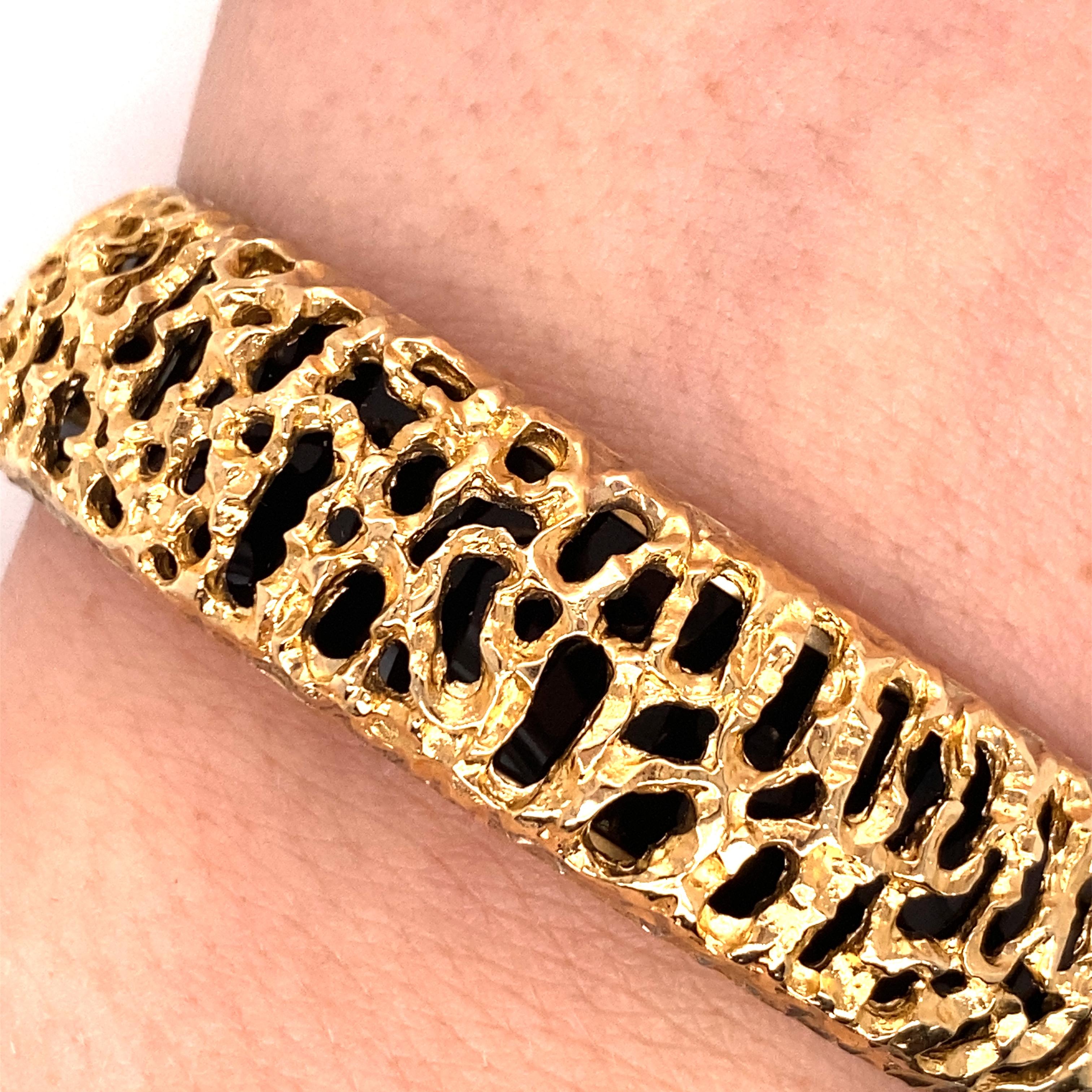 Vintage 1980's 14K Yellow Gold Bangle Bracelet with Filigree and Onyx - The bracelet has onyx inside a beautiful filigree design. The width of the bangle is .65 inches. The inside diameter is 2 inches high by 2.35 inches wide. The inside is stamped