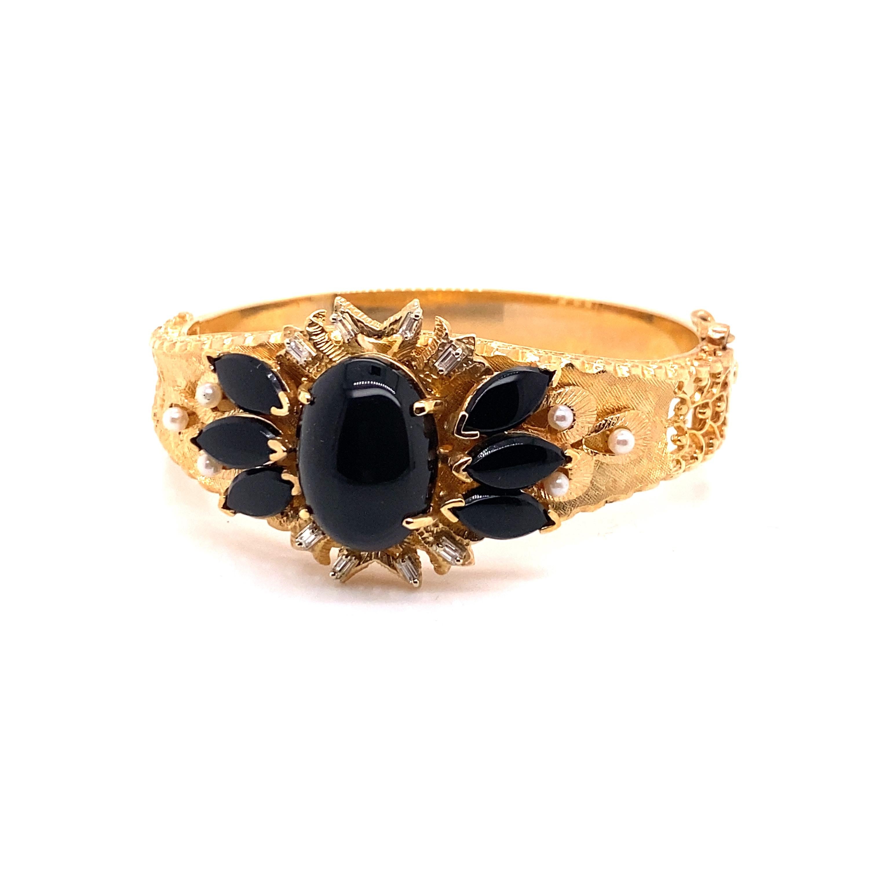 Vintage 1980's 14K Yellow Gold Onyx Bangle Bracelet - The center oval onyx measures 18 x 13mm, and the 3 marquise onyx on each side measure 10 x 5mm. The bangle contains 8 straight baguette diamonds and 6 seed pearls for added detail. The diamonds