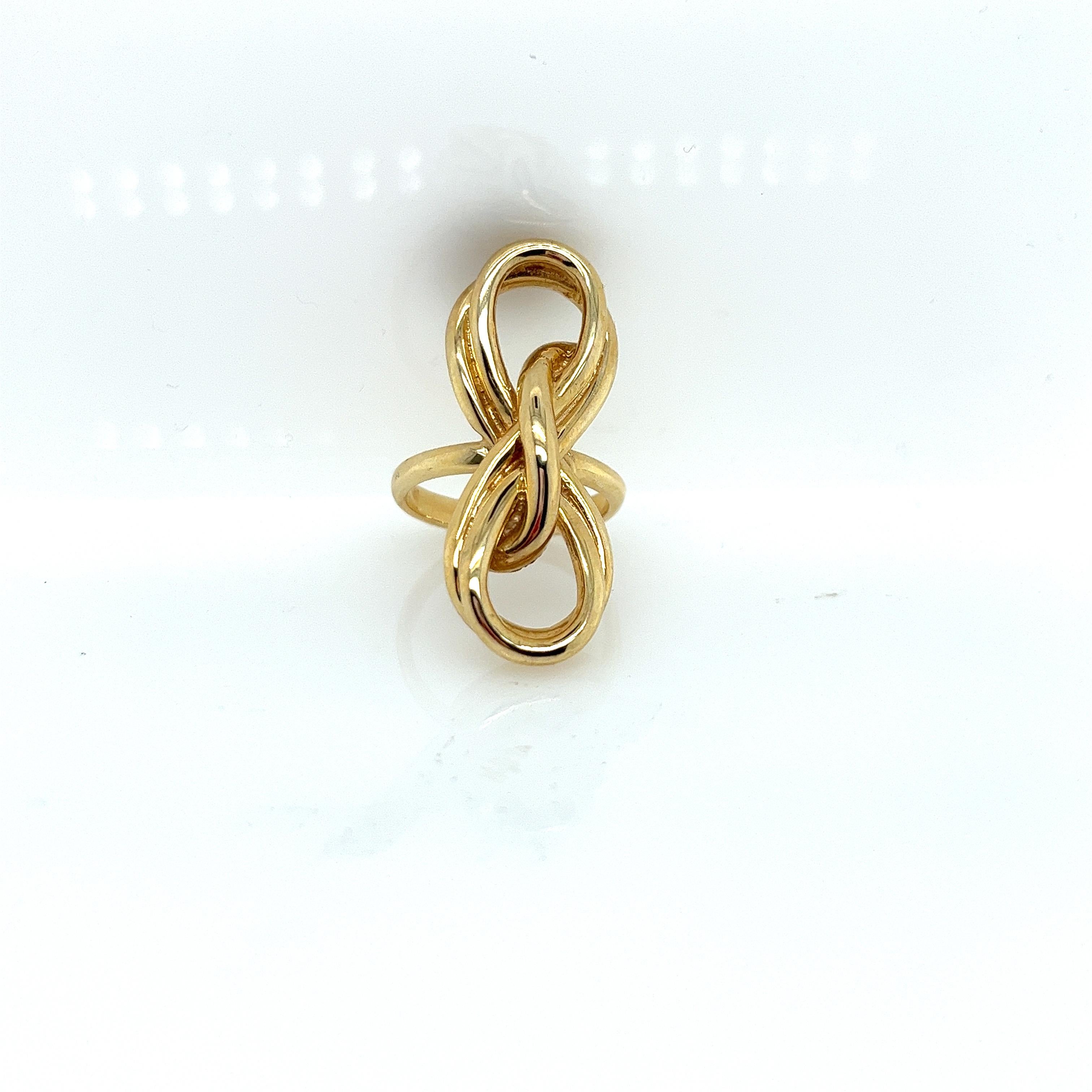 Vintage 1980's 14k Yellow Gold Ribbon Statement Ring. The ribbon measures 34mm long and 14mm wide. The ribbon sits 6mm high off the finger. The width of the band is 2.5mm and gets a little wide on the bottom to 2.9mm. The finger size is 6.75 and it