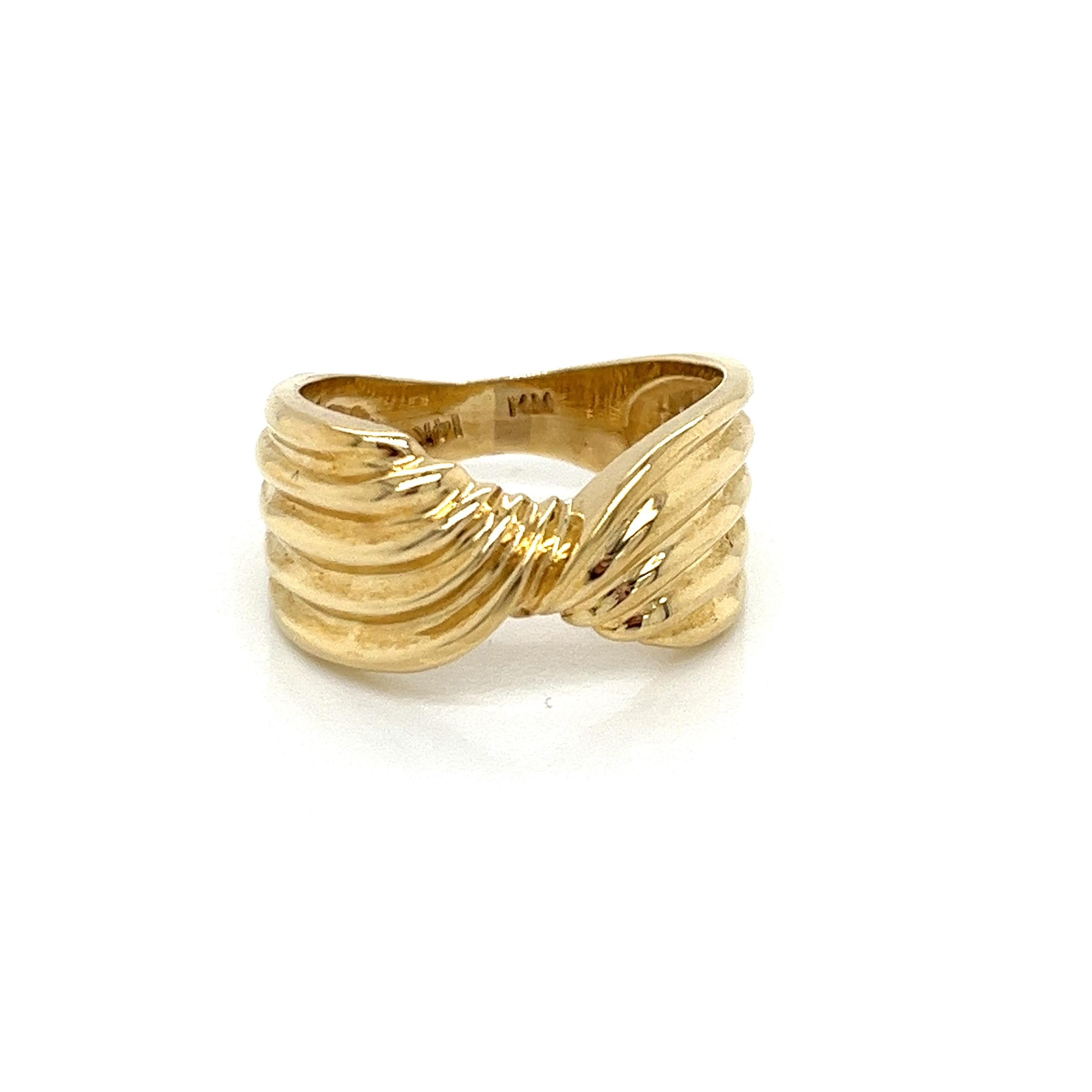 Vintage 1980's 14k Yellow Gold Twist Ribbon Design Statement Ring. The width of the ring is 9.8mm and tapers to 3.5mm wide. The finger size is 6 and it can be sized upon request. The ring weighs 5.35g. 