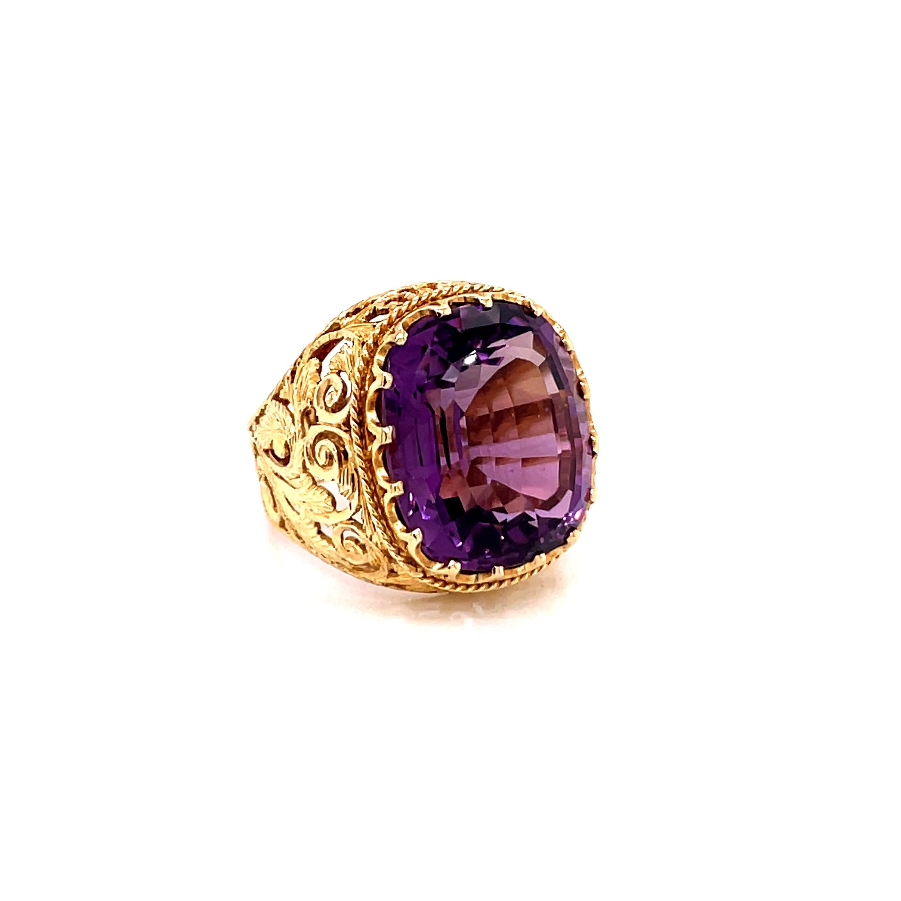 Vintage 1980's 15ct Cushion Cut Amethyst Ring - the amethyst weighs approximately 15ct and measures 17.6 x 14.8mm.  The setting is an 18k yellow gold hand carved filigree setting with a finger size 8 which can be sized upon request.  The ring weighs