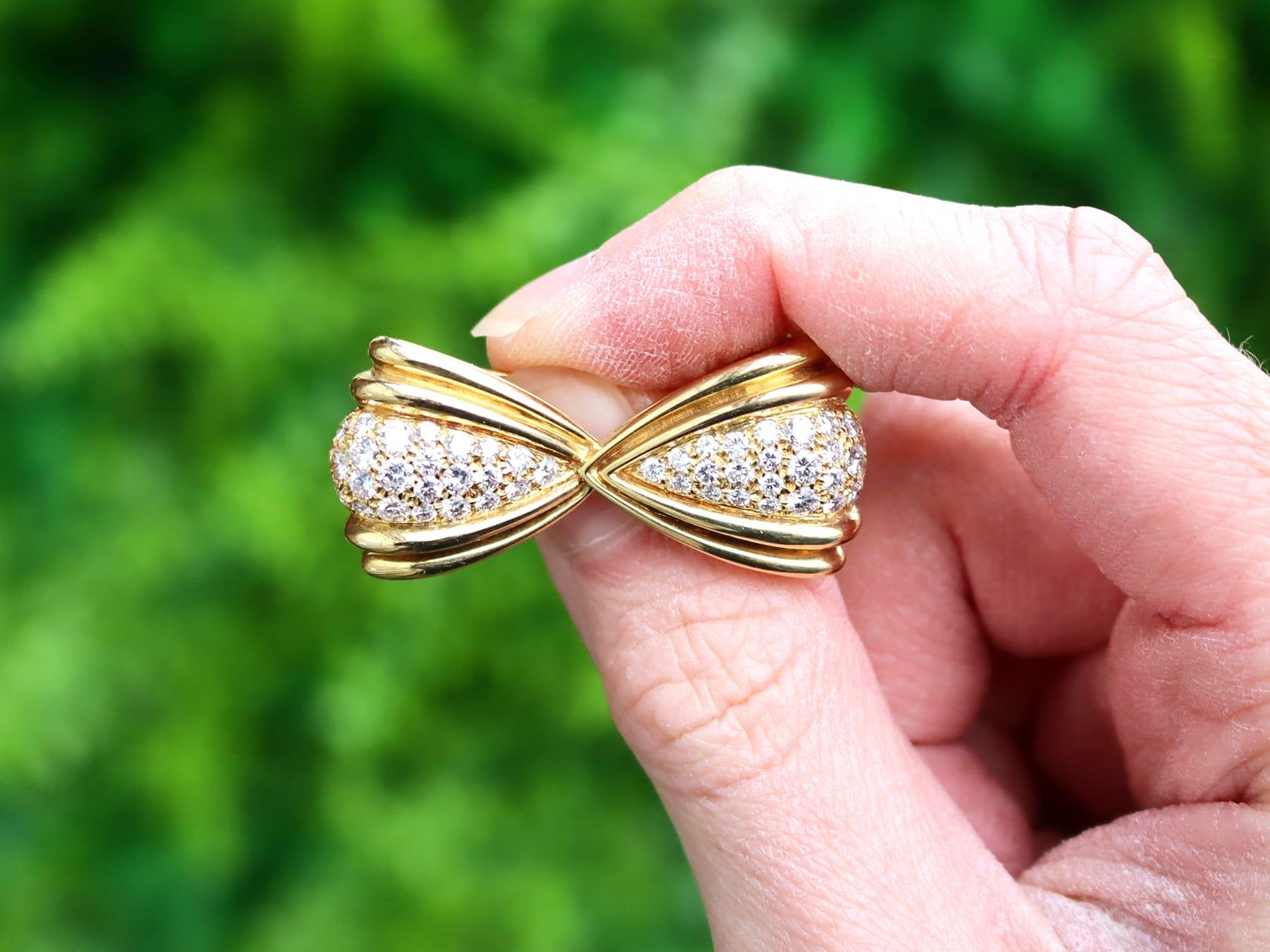 An impressive vintage 1.68 carat diamond and 18 karat yellow gold bow brooch; part of our diverse vintage jewelry and estate jewelry collections.

This fine and impressive vintage bow brooch with diamonds has been crafted in 18k yellow gold.

The