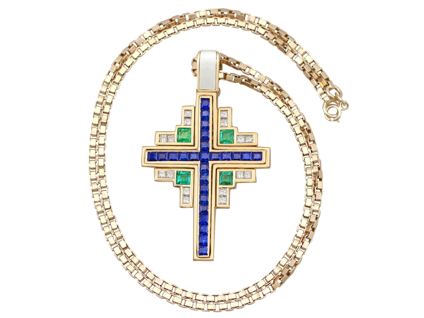 A stunning vintage 1.75 carat sapphire and 1 carat emerald, 0.96 carat diamond and 18 karat yellow gold cross pendant; part of our diverse gemstone jewelry and estate jewelry collections.

This stunning, fine and impressive pendant has been crafted