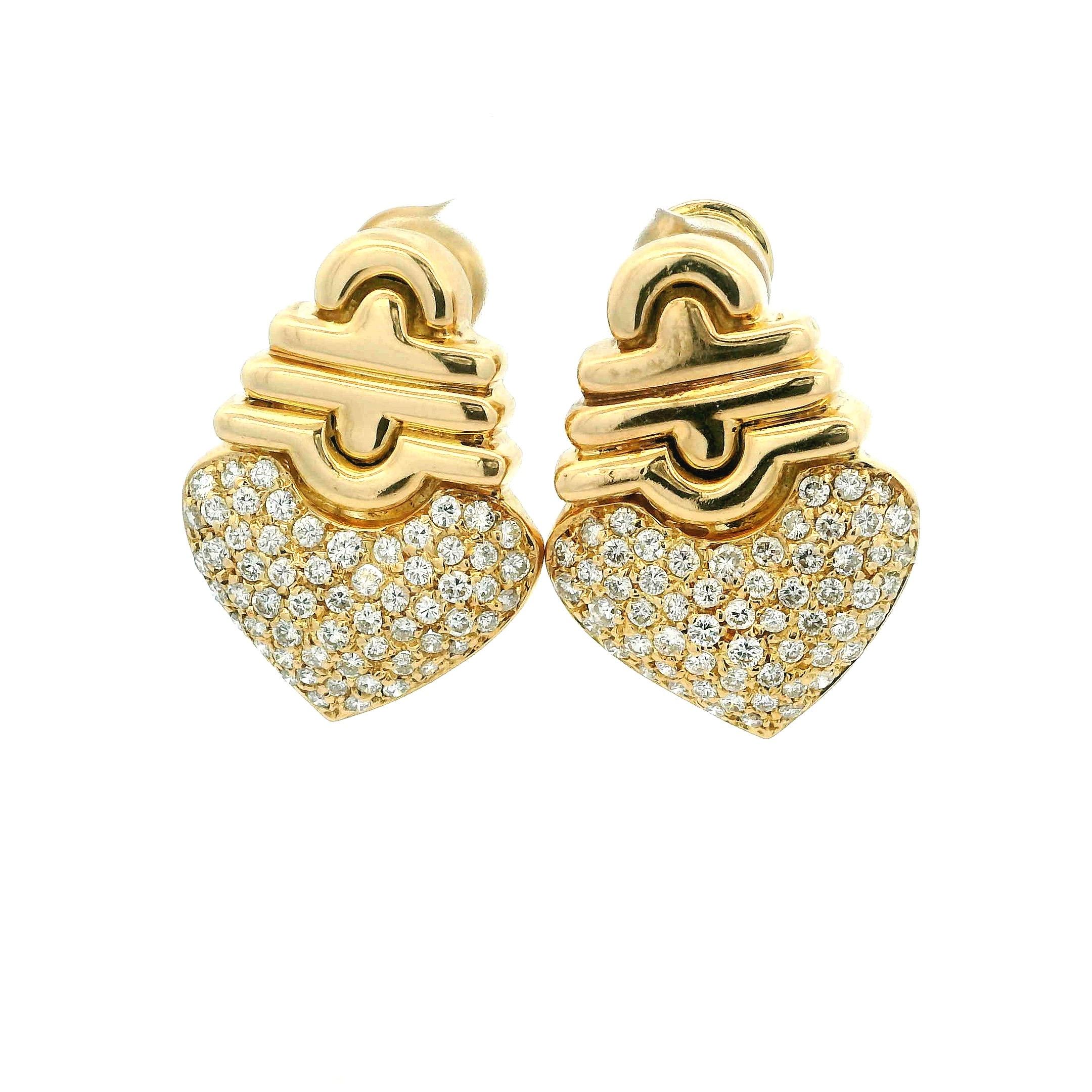 A romantic pair, these 1980s Retro heart motif earrings are masterfully crafted in solid 18K yellow gold and set with approximately 3.00 carats of shimmering round brilliant diamonds in a heart-shaped pave design. The upper section features a