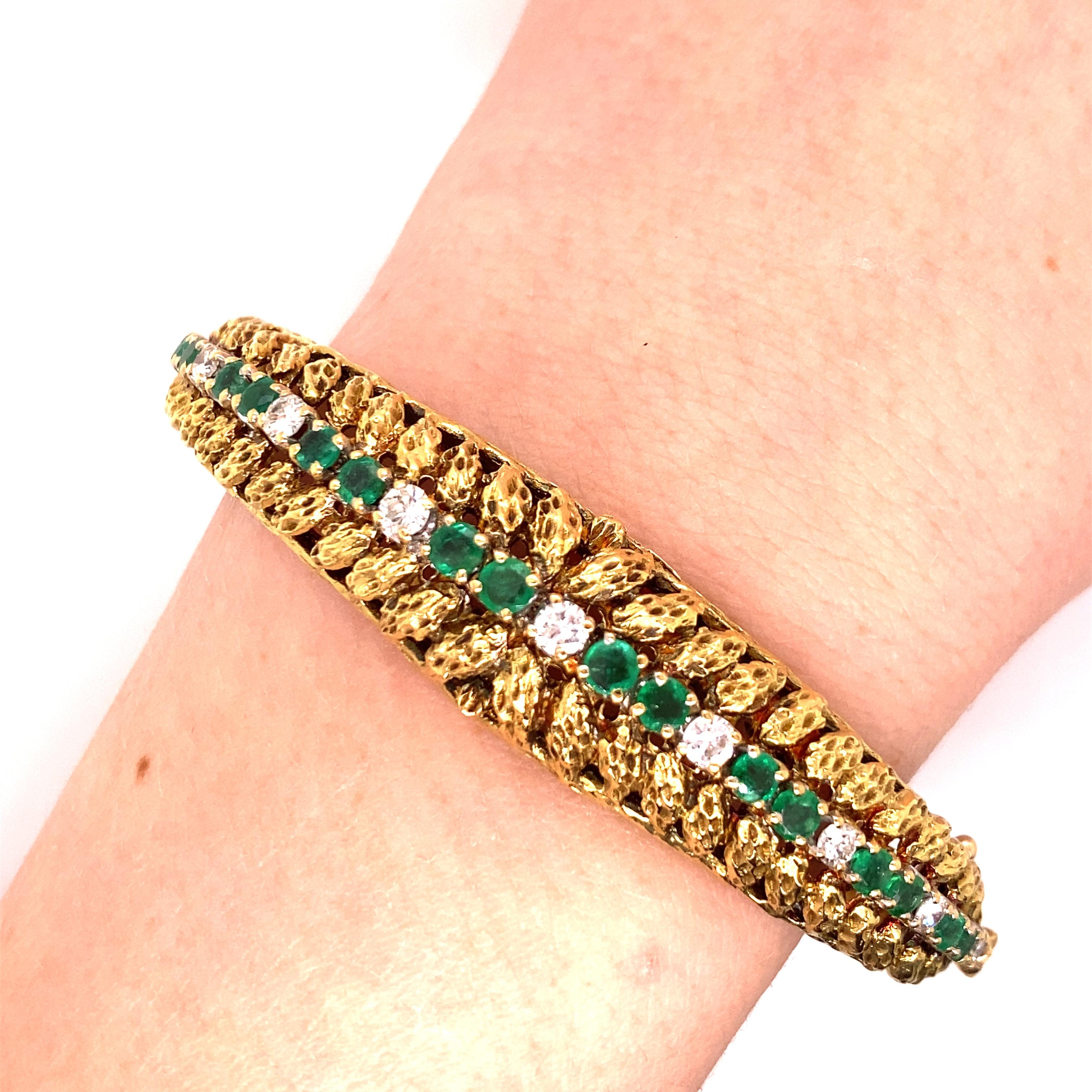 Vintage 1980's 18K Yellow Gold Emerald and Diamond Bangle - There are 19 round emeralds graduated in size with a total approximate weight of 1.62ct and very fine green color. There are 10 round brilliant diamonds with a total approximate weight of