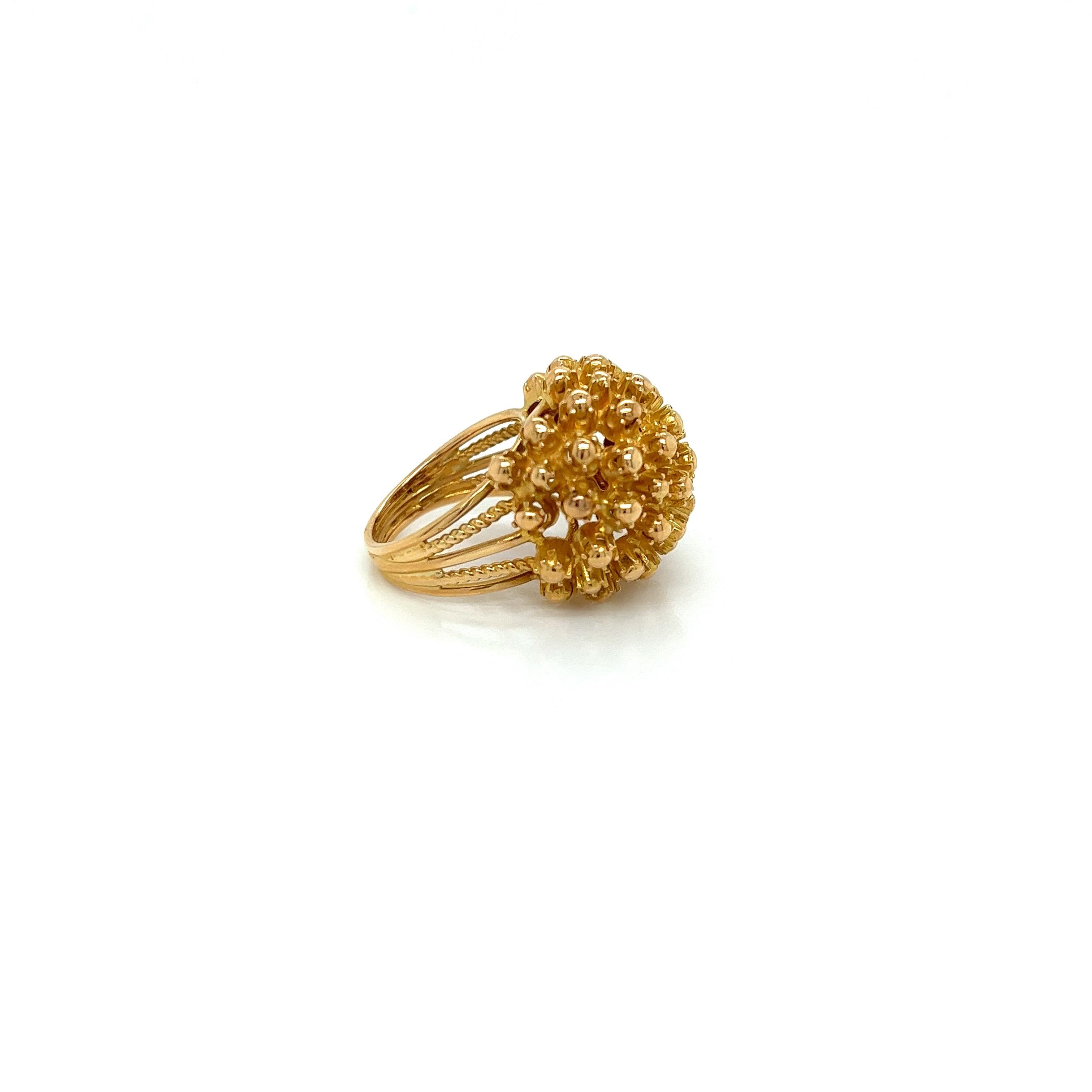 Vintage 1980's 18k Yellow Gold Flower Statement Ring. The 18ky flower measures 19mm wide and 12mm high off the finger. The 5 row split band measures 9mm wide and tapers to 3.5mm wide on the bottom. The finger size is 4 and it can be sized upon
