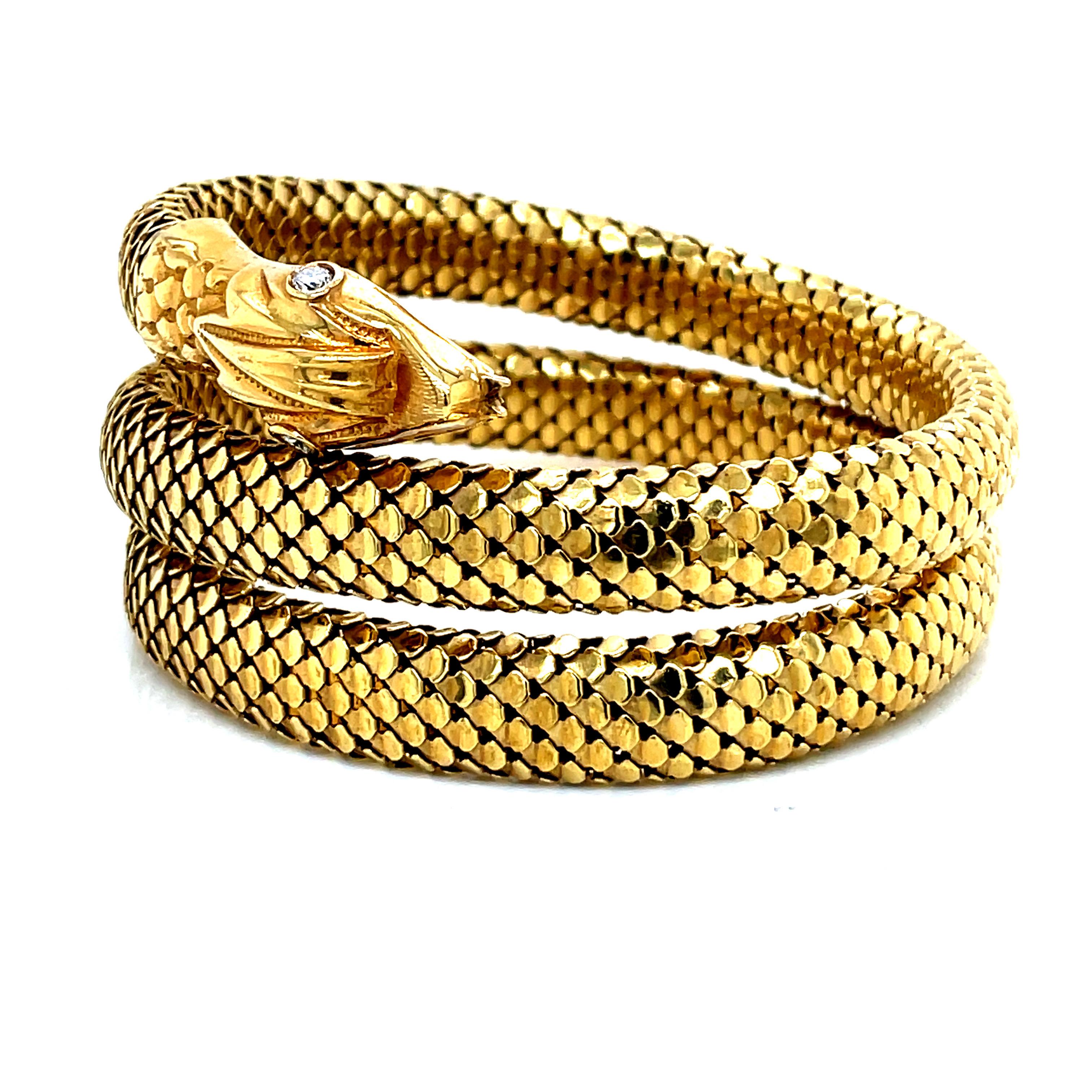 The vintage snake bracelet is a striking and intricate 18k yellow gold piece showcasing exceptional craftsmanship. The flexible mesh design allows it to be worn as a bracelet or an armband, adapting to different wrist and arm sizes. With a width of