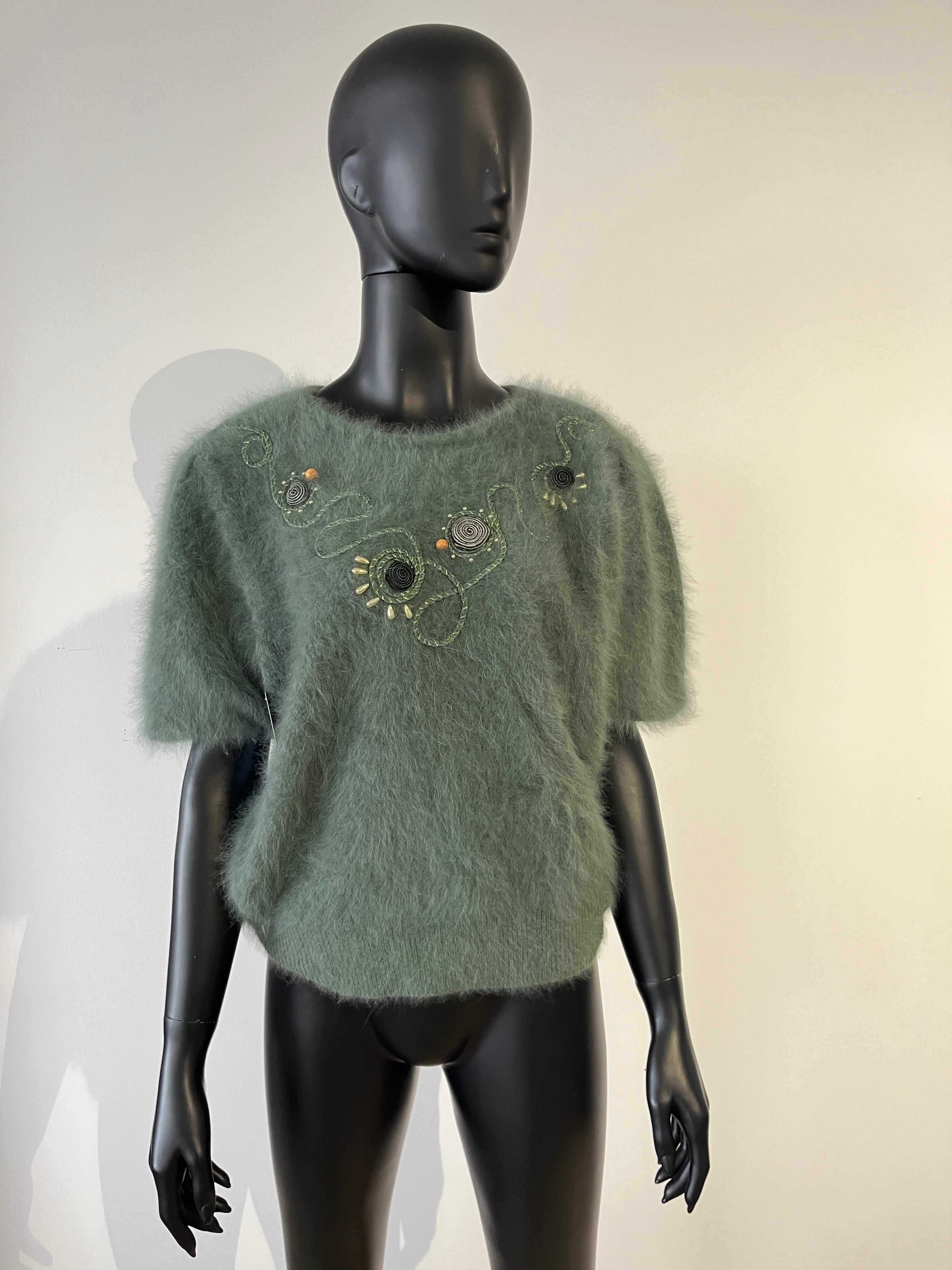 Vintage 1980’s fluffy angora sweater in sage green.
Short sleeve pullover with abstract rope embroidery and wooden beads. 
Warm and soft.
Would fit most sizes.

