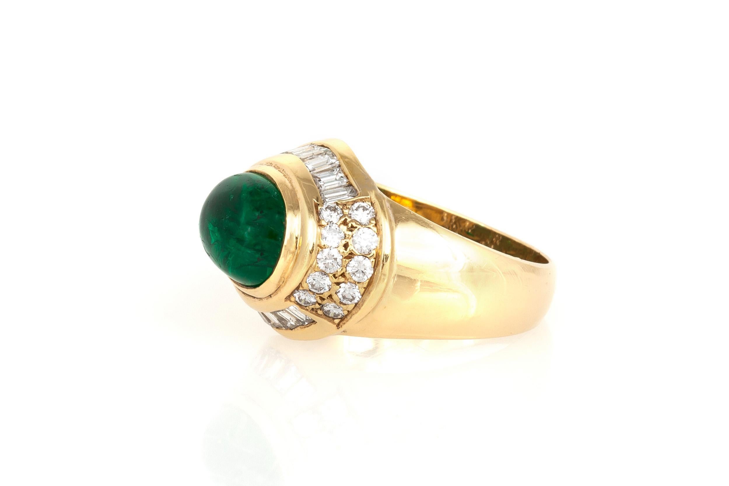 Finely crafted in 18K yellow gold with a Cabochon Emerald weighing 2.69 carats surrounded by Round Brilliant and Baguette cut Diamonds weighing a total of 2.18 carats. 
Circa 1980s
Size 6 3/4, resizable