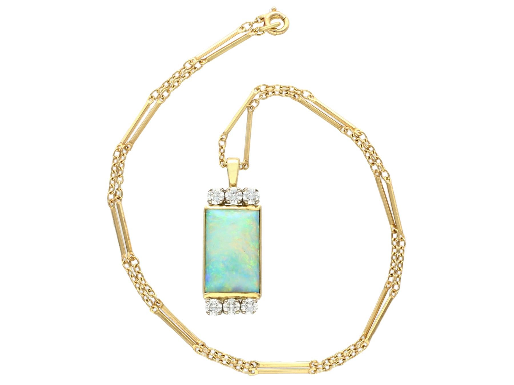 A fine and impressive 3.18 carat opal and 0.63 carat diamond, 18 karat yellow and white gold pendant; part of our diverse antique jewelry and estate jewelry collections.

This fine and impressive vintage opal pendant has been crafted in 18k yellow