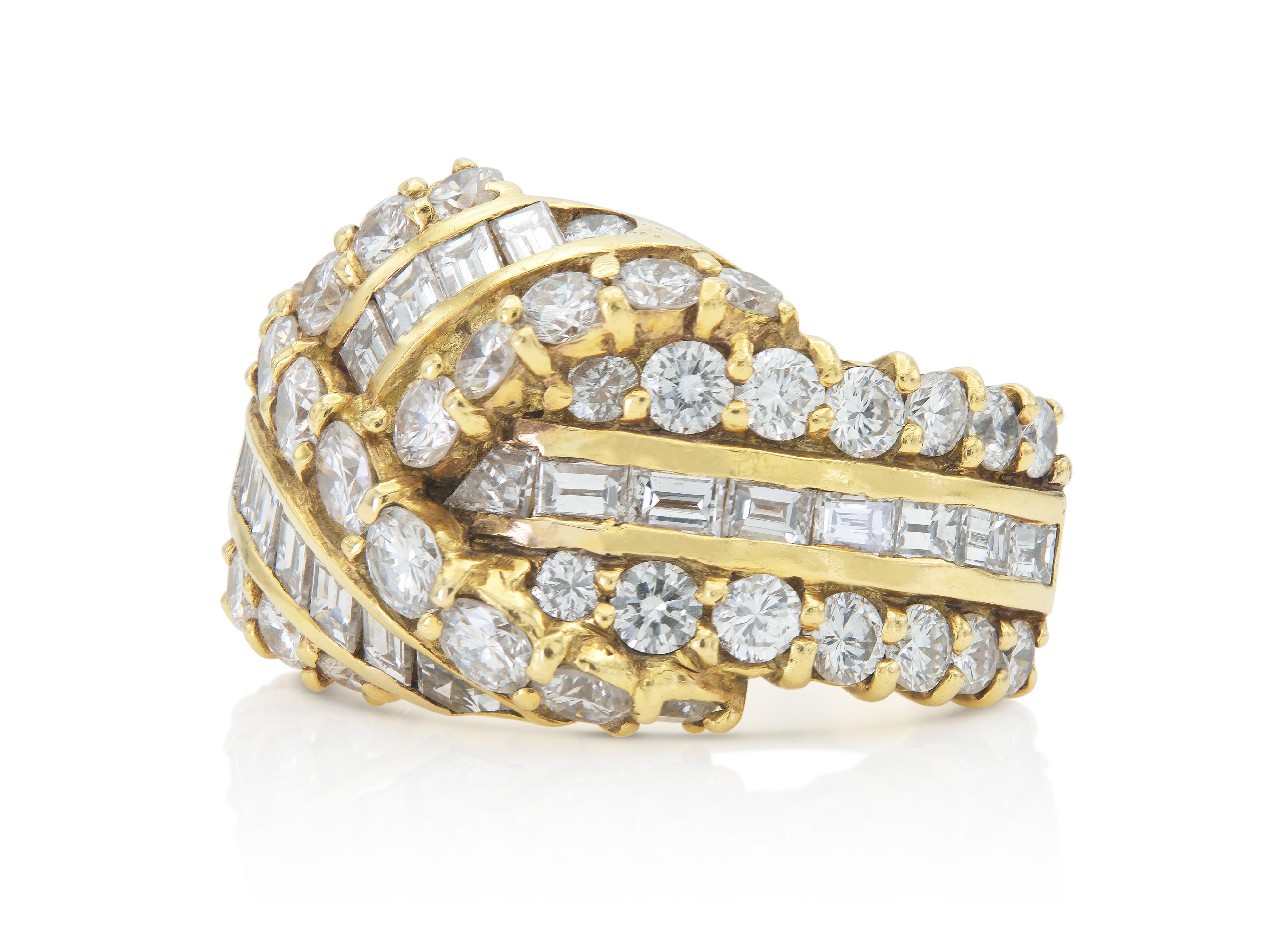 Finely crafted in 18k yellow gold featuring Baguette and Round Brilliant cut Diamonds weighing a total of approximately 3.80 carats, G-H color, VS1-VS2 clarity.
Circa 1980s
Size 5 3/4, resizable