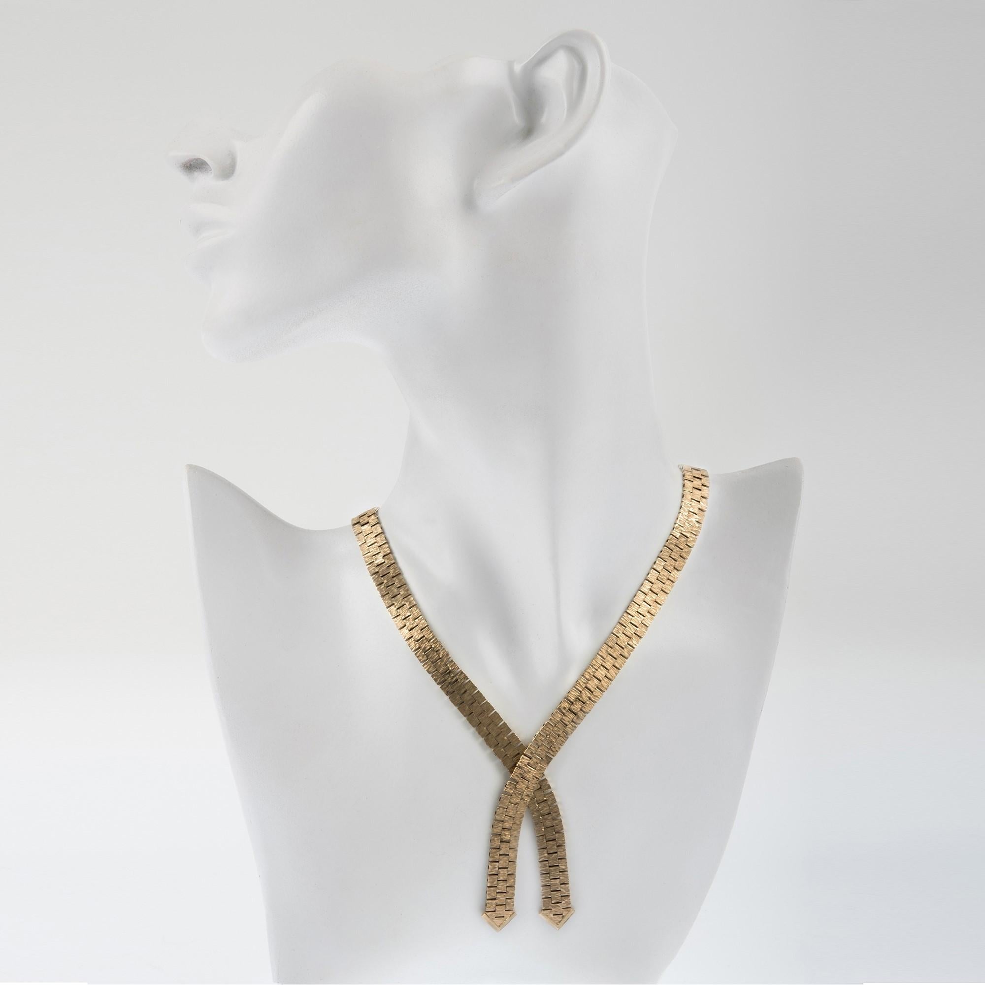 This sleek and stylish 9ct yellow gold necklace is crafted from textured flat book chain and exhibits a brick like pattern. A wonderful vintage style and a unique and beautiful gift for a gold occasion or birthday.