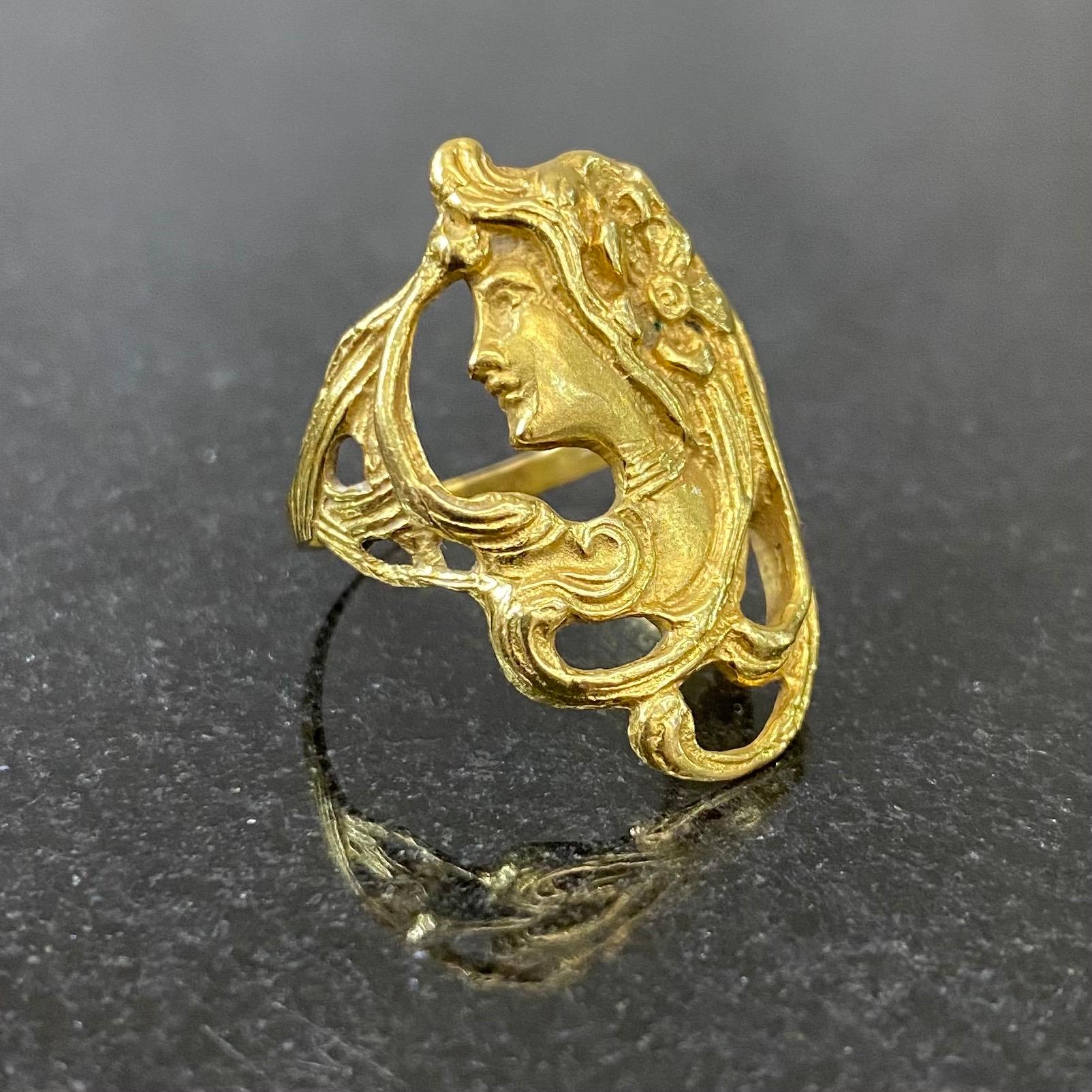 Vintage Art Nouveau Style Female Figure Ring in 19.2 Karat Yellow Gold, Signed, Portugal, 1980s. This openwork carved ring is modelled as a woman in profile looking to the left, her hair dancing in the wind and embellished with a flower, flowing