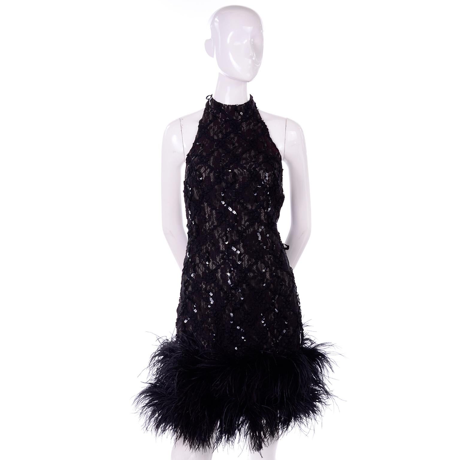 This is a stunning vintage black lace halter dress, covered with sequins and trimmed with black ostrich feathers. The dress has a halter neck and there is a small amount of burgundy in the lace.  Perfect for cocktail parties, special occasions and