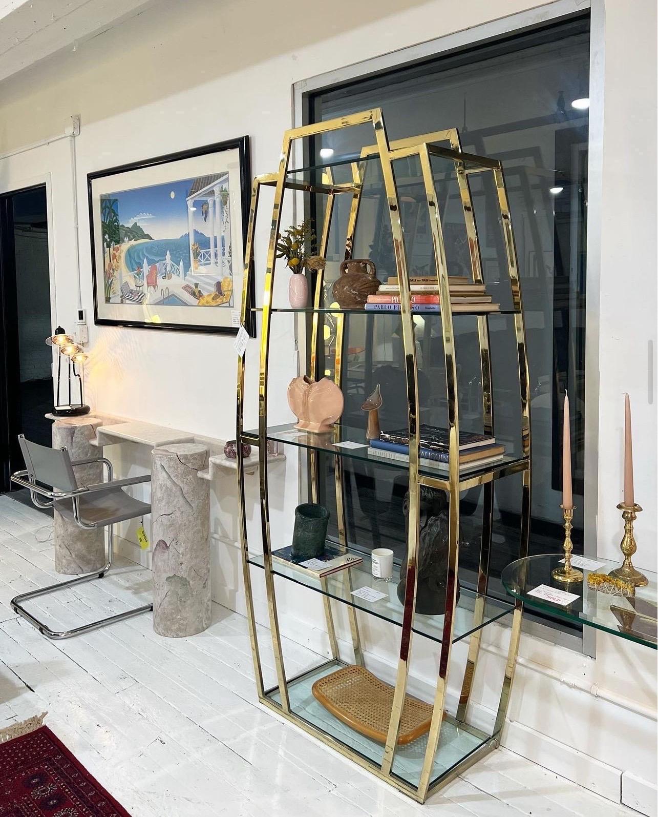 Gorgeous 1980s brass & glass Etagere 

Features 5 glass shelves for all of your styling and storage needs.