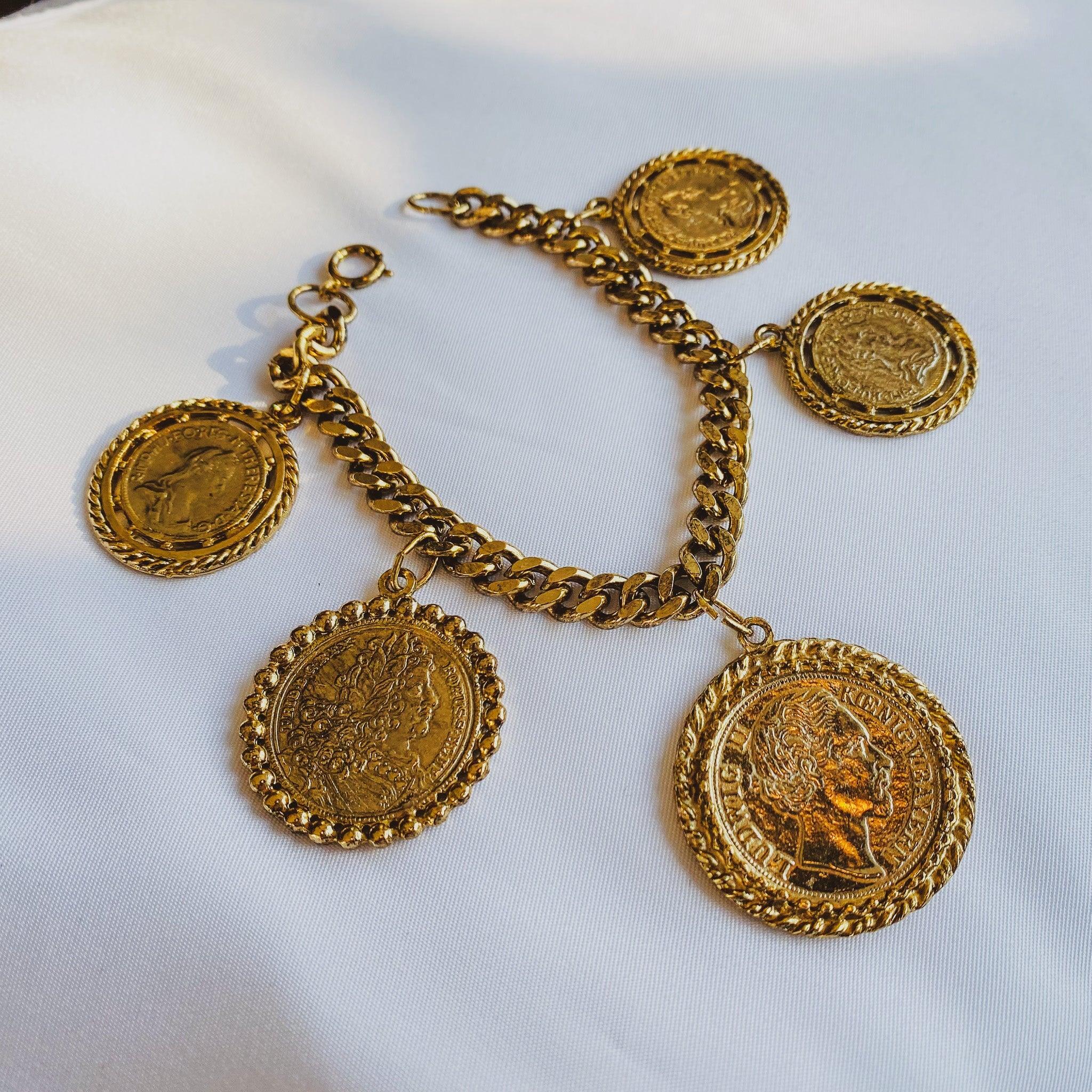 
Vintage 1980s Medallion Charm Bracelet
 

A super cool statement vintage charm bracelet. Made in the 1980s in the UK from high quality gold coloured metal. Features a chunky gold plated 7