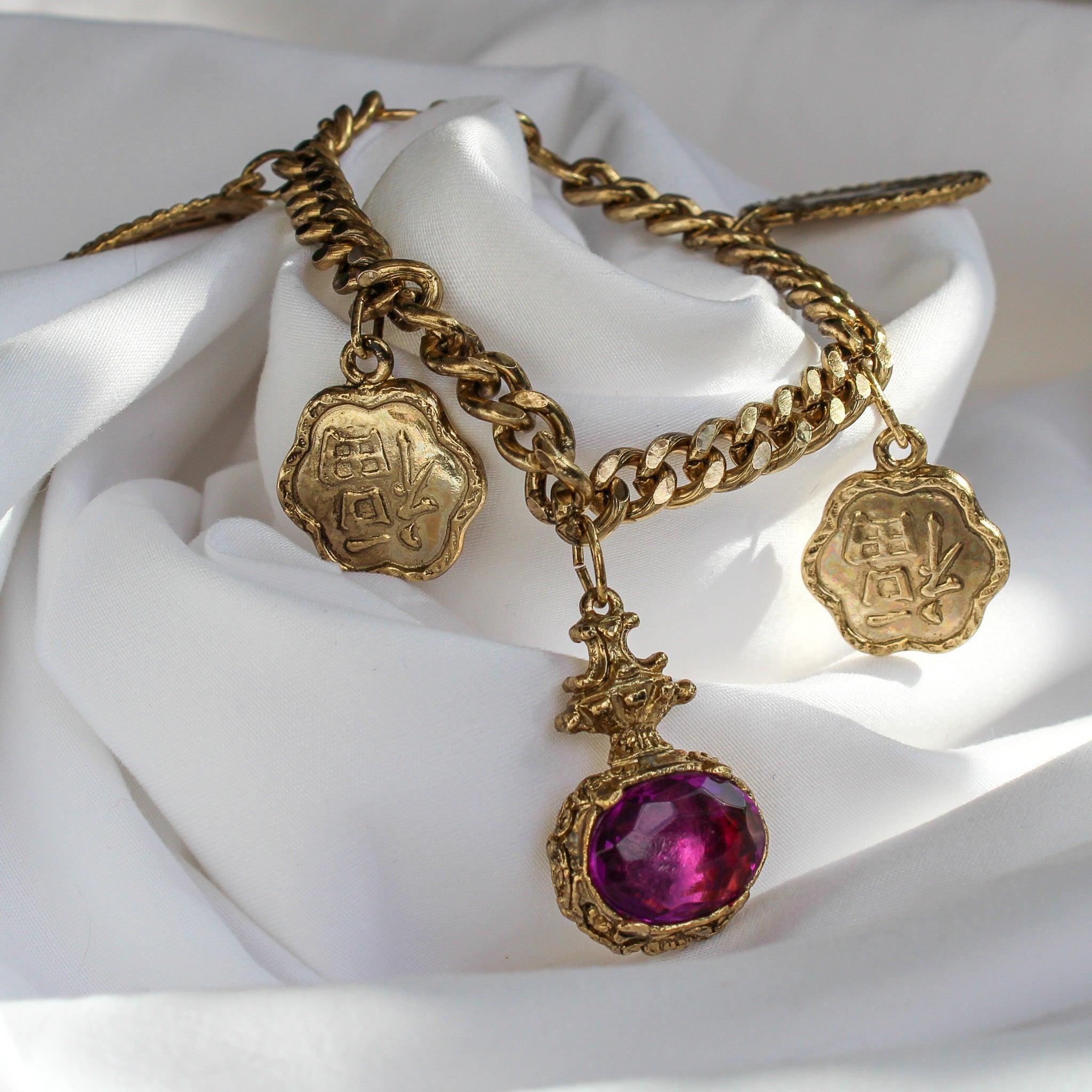 Vintage 1980s Charm Bracelet
 
Meet this effortlessly cool vintage 1980s charm bracelet, carefully crafted in the UK from high-quality materials . This stylish piece features a chunky gold-plated curb chain, adorned with eye-catching large coin