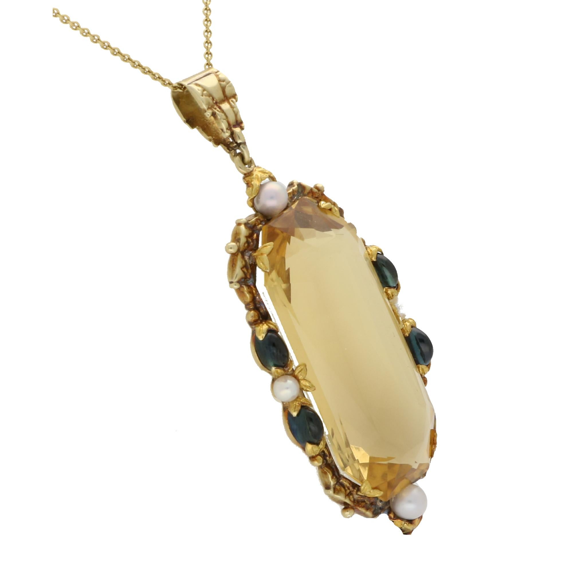 A spectacular vintage citrine, sapphire and pearl pendant set in 14k yellow gold. 

The pendant is set with an astounding mixed cut citrine which is securely claw set in a decorative mount. The citrine is surrounded by cabochon blue sapphires and