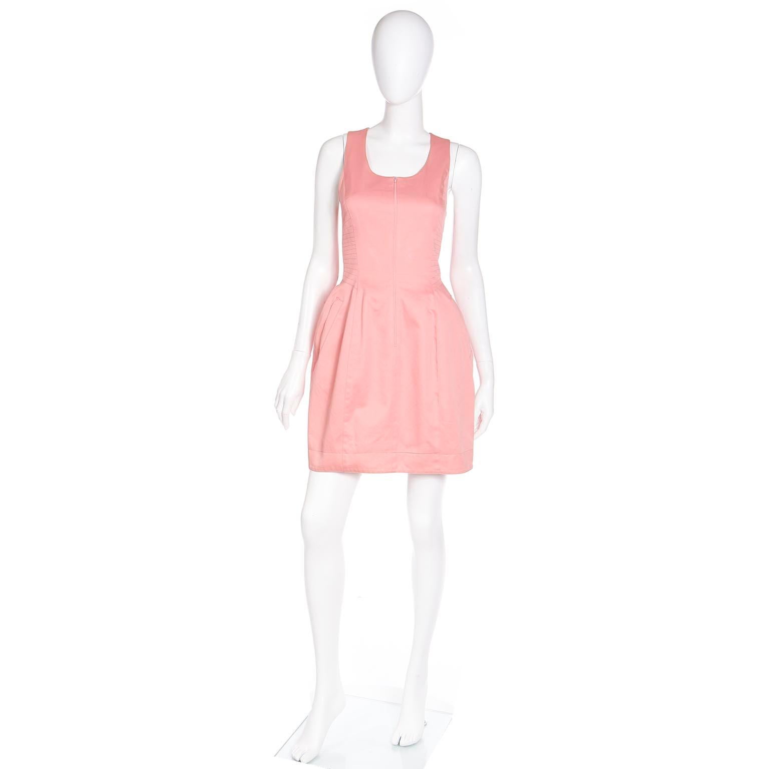 This vintage 1980's Claude Montana peachy pink cotton sleeveless mini dress has so many subtle details that make it so flattering! Claude Montana was a contemporary (and one time roomate) of Thierry Mugler. Both Mugler and Montana helped to define
