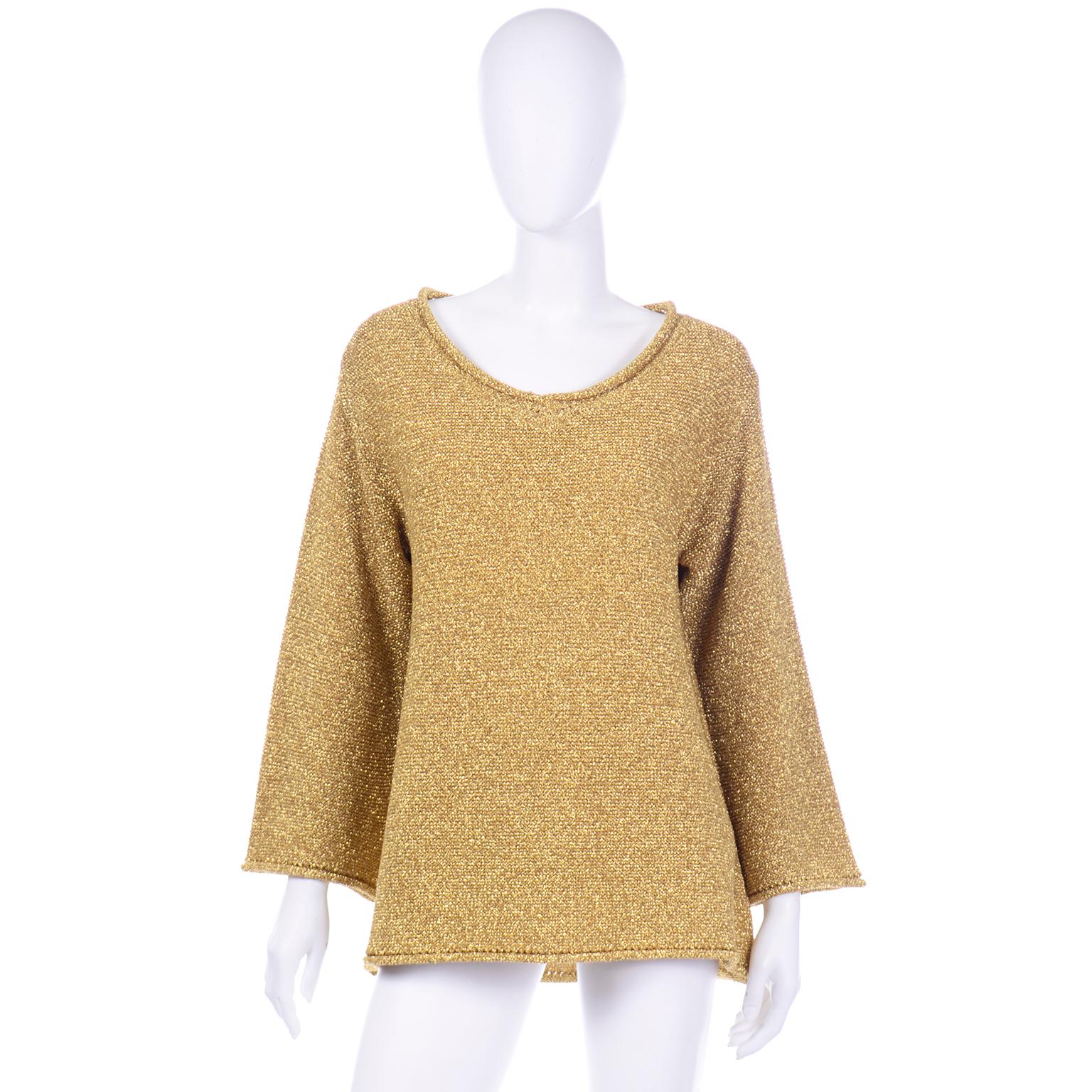 This is such a stunning vintage 1980's gold metallic knit pullover sweater from Claude Montana. This beautiful top has a slightly scooped round neckline with an open knit and rolled edge that is also found around the cuffs of the sleeves and hem.