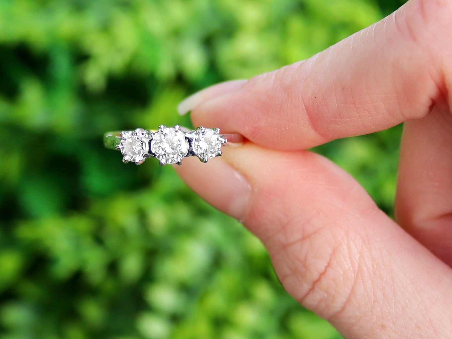 A fine and impressive vintage 0.93 carat diamond and 18 karat yellow gold, platinum set three stone/trilogy ring; part of our vintage jewelry and estate jewelry collections.

This impressive vintage diamond trilogy ring has been crafted in 18k