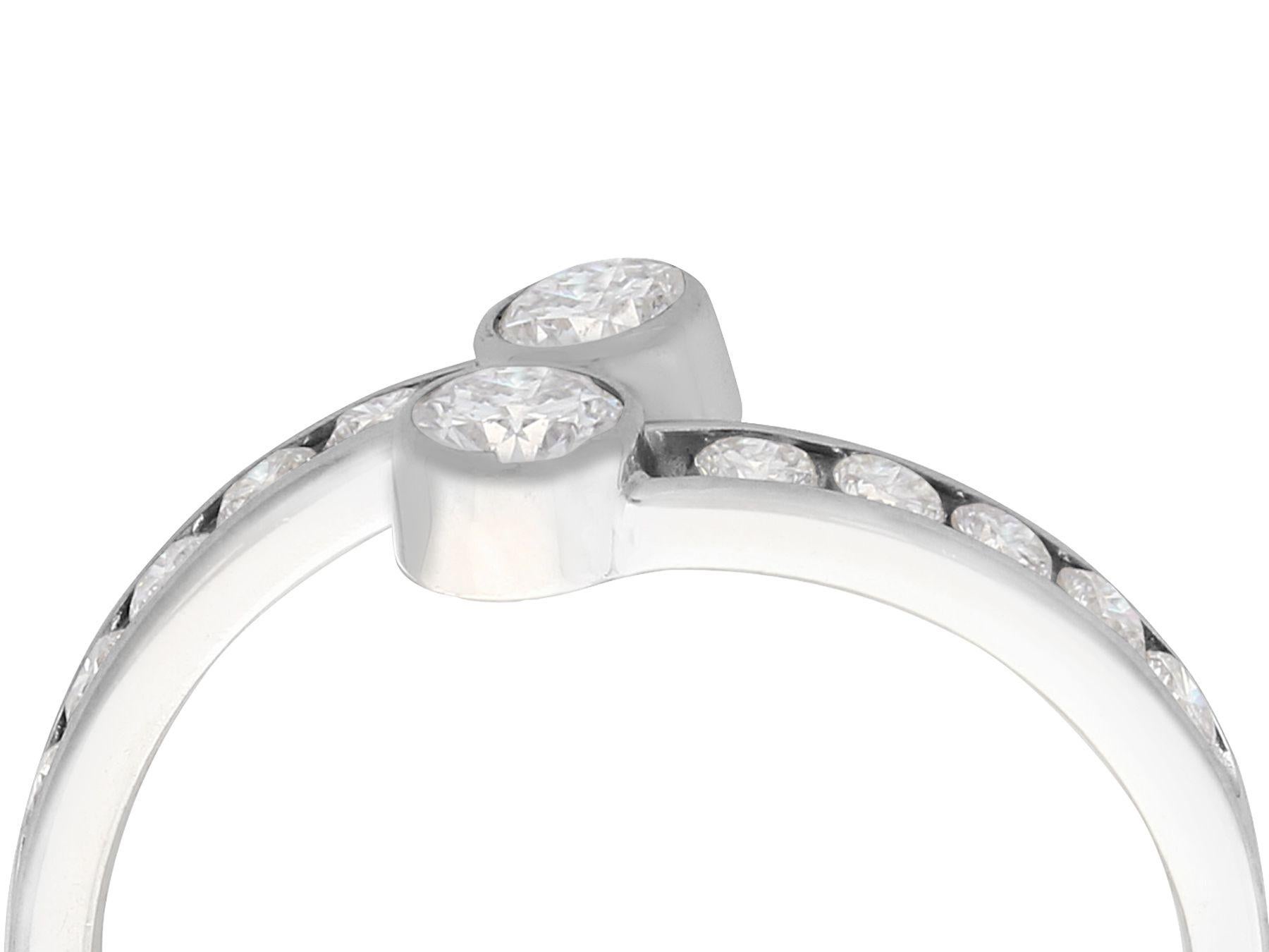 A fine 0.50 carat diamond and 14 karat white gold twist ring; part of our vintage jewelry and estate jewelry collections.

This fine vintage diamond ring has been crafted in 14k white gold.

The white gold twist ring features two bezel set 0.15Ct