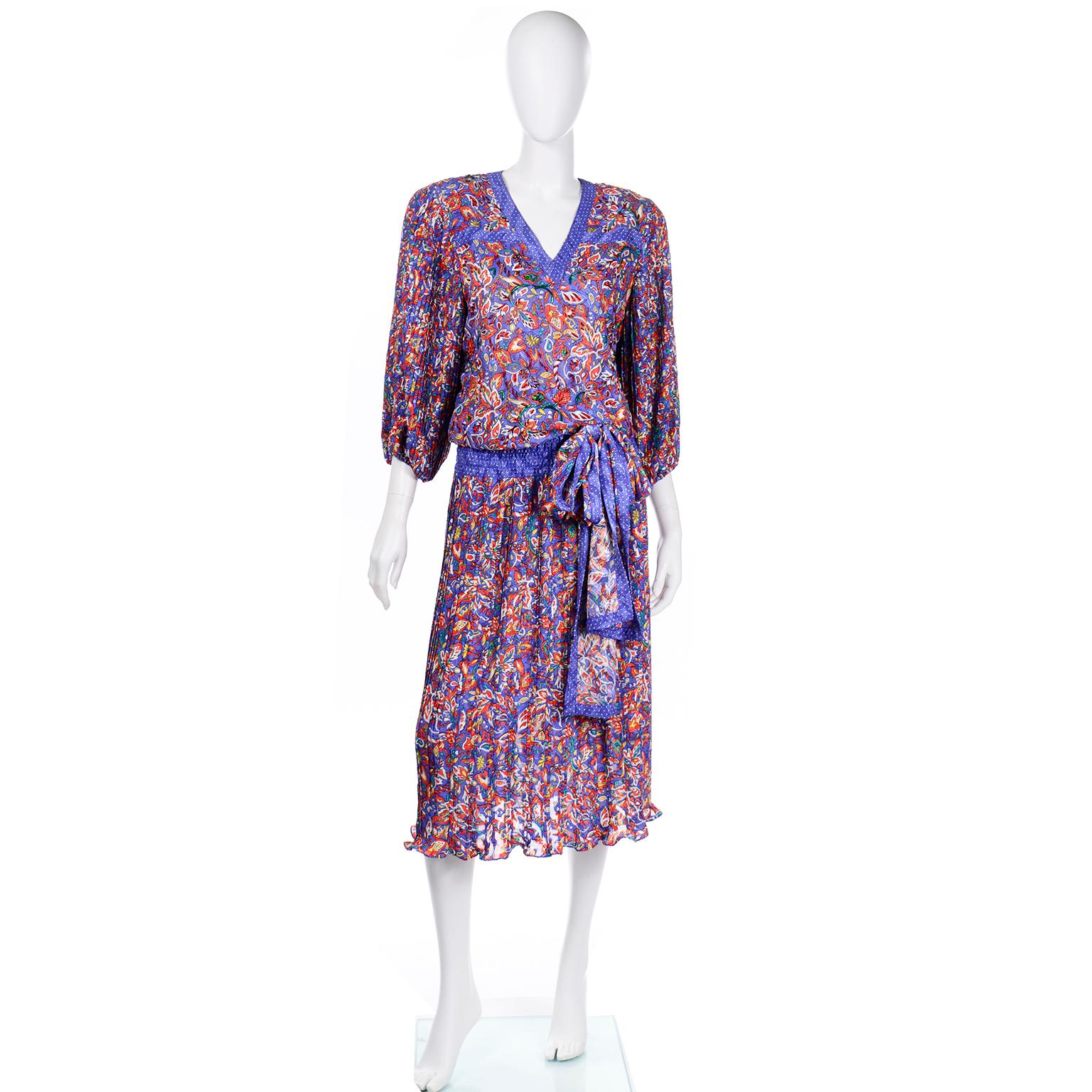 This is a 1980's vintage Diane Freis colorful, bold dress with an elasticized waistband and mirco-pleated balloon sleeves. We love vintage Diane Freis prints and this one is a mixed pattern jacquard print in shades of blue, orange, white, yellow,