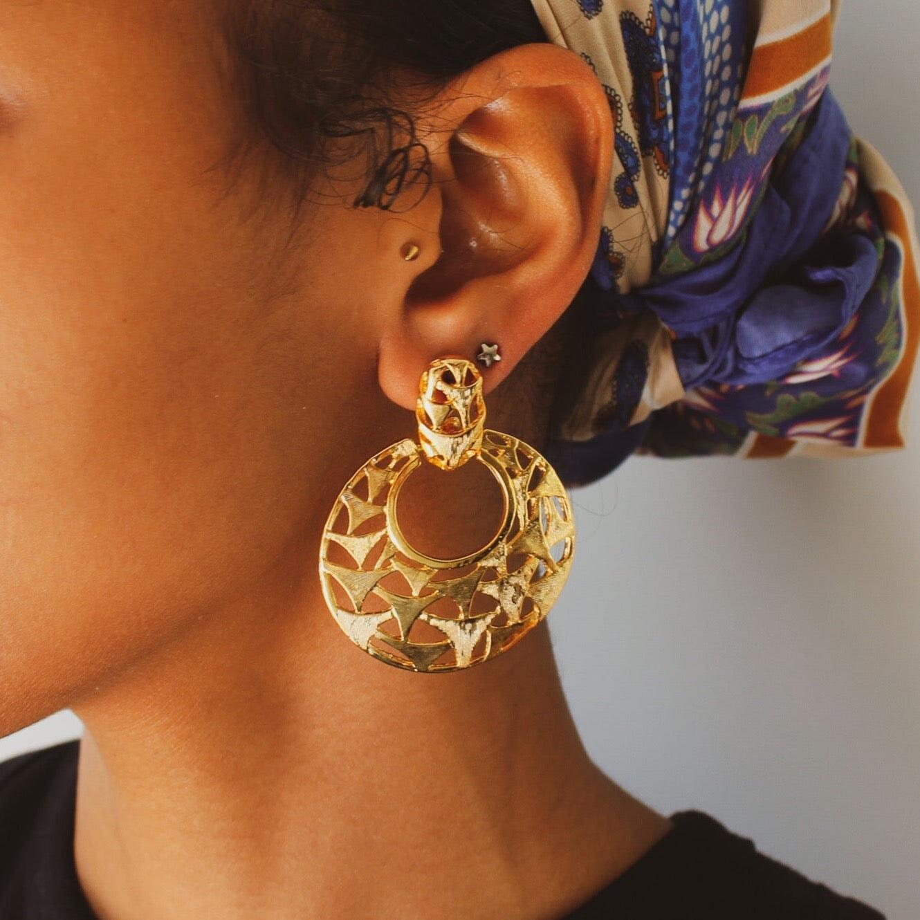 
Vintage 1980s Earrings 
 

Celebrate the high voltage spirit of the 1980s with these oversized, statement earrings crafted in the UK. 

Their intricate openwork pattern is bathed in 18-carat gold plating, and as deadstock, these earrings carry with