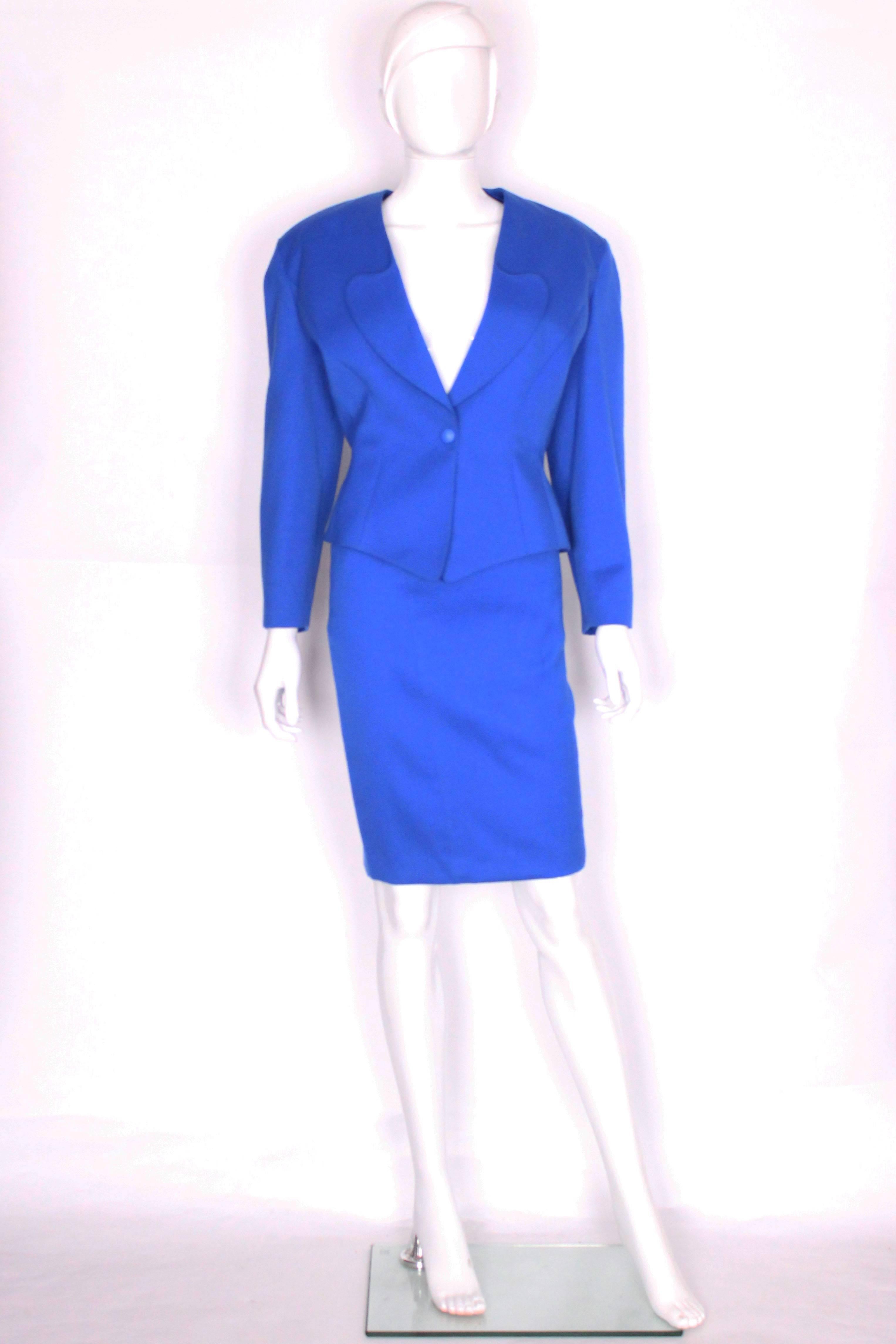 A great 'power suit' from the 1980s by Mugler par Thierry Mugler. In an electric blue wool, this suit comprises a pencil skirt and matching jacket The jacket has a v neckline and lower lapels,  and wonderful tailoring. It fastens with a single