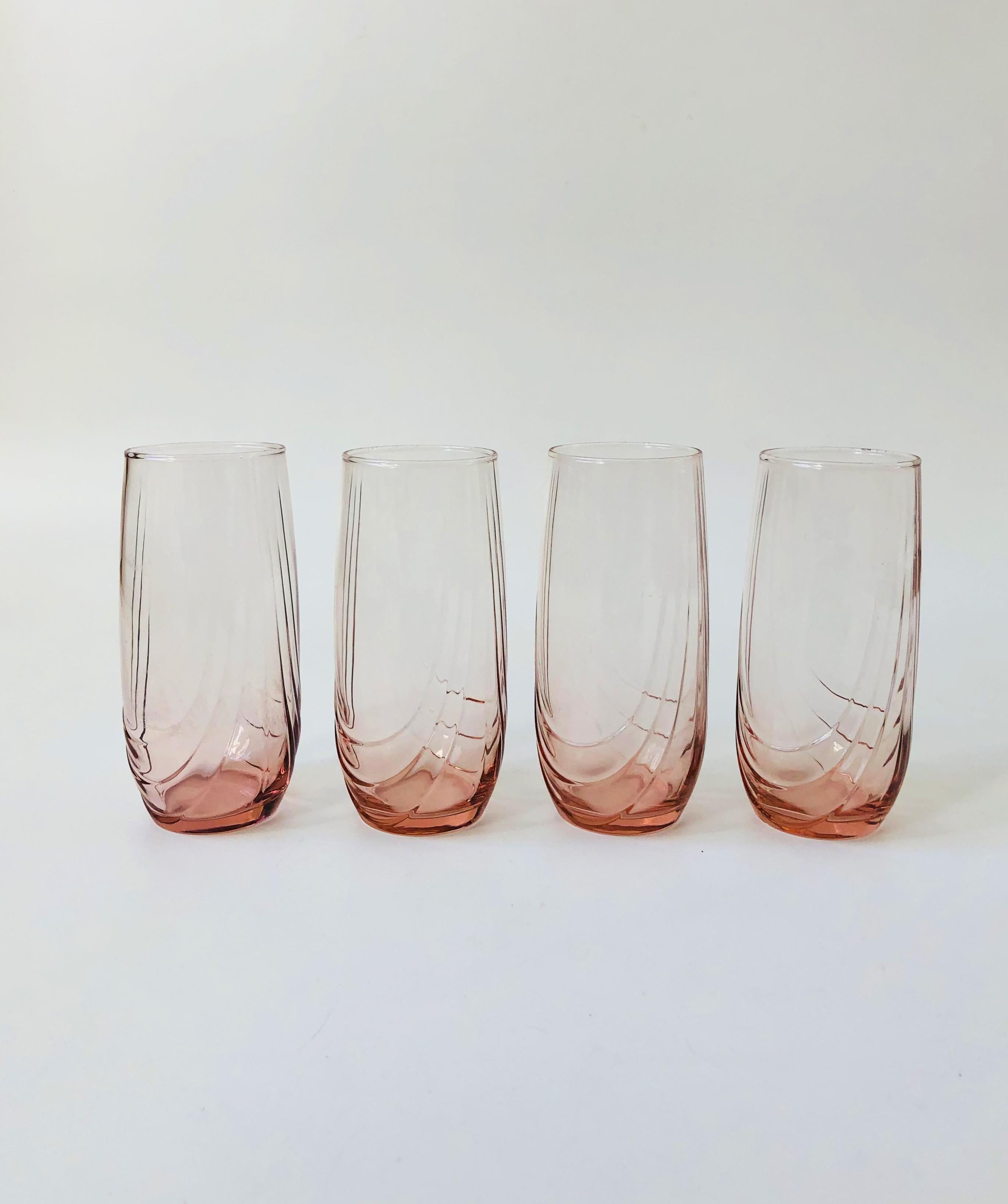 A set of 4 vintage 1980s highball tumblers. Beautiful pale pink color with a unique embossed detailing to the sides. Perfect for using for cocktails or everyday water glasses.
  