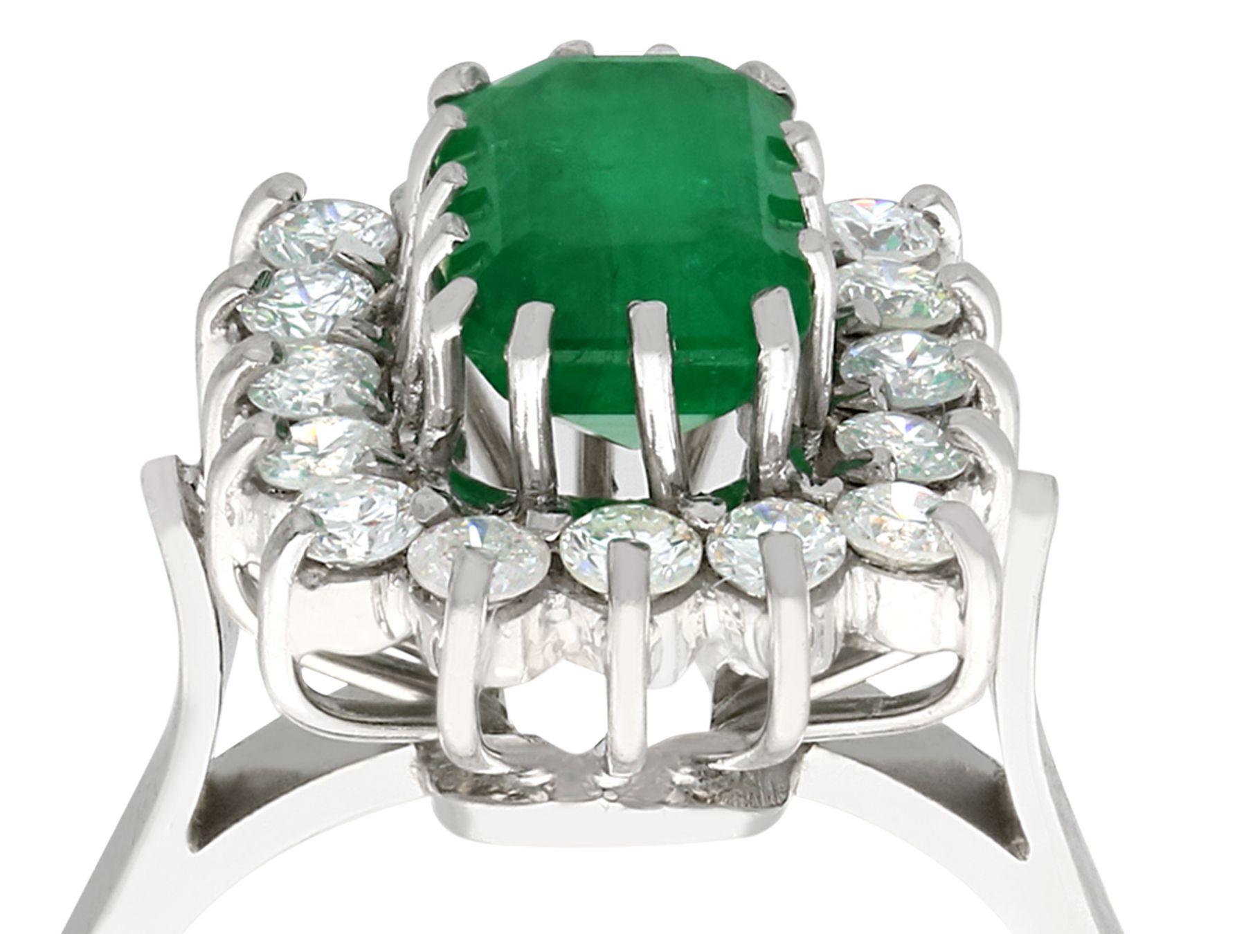 An impressive vintage 2.19 carat emerald and 0.65 carat diamond, 18 karat white gold cluster ring; an addition to our vintage jewelry and estate jewelry collections.

This fine and impressive diamond and emerald cocktail ring has been crafted in 18k