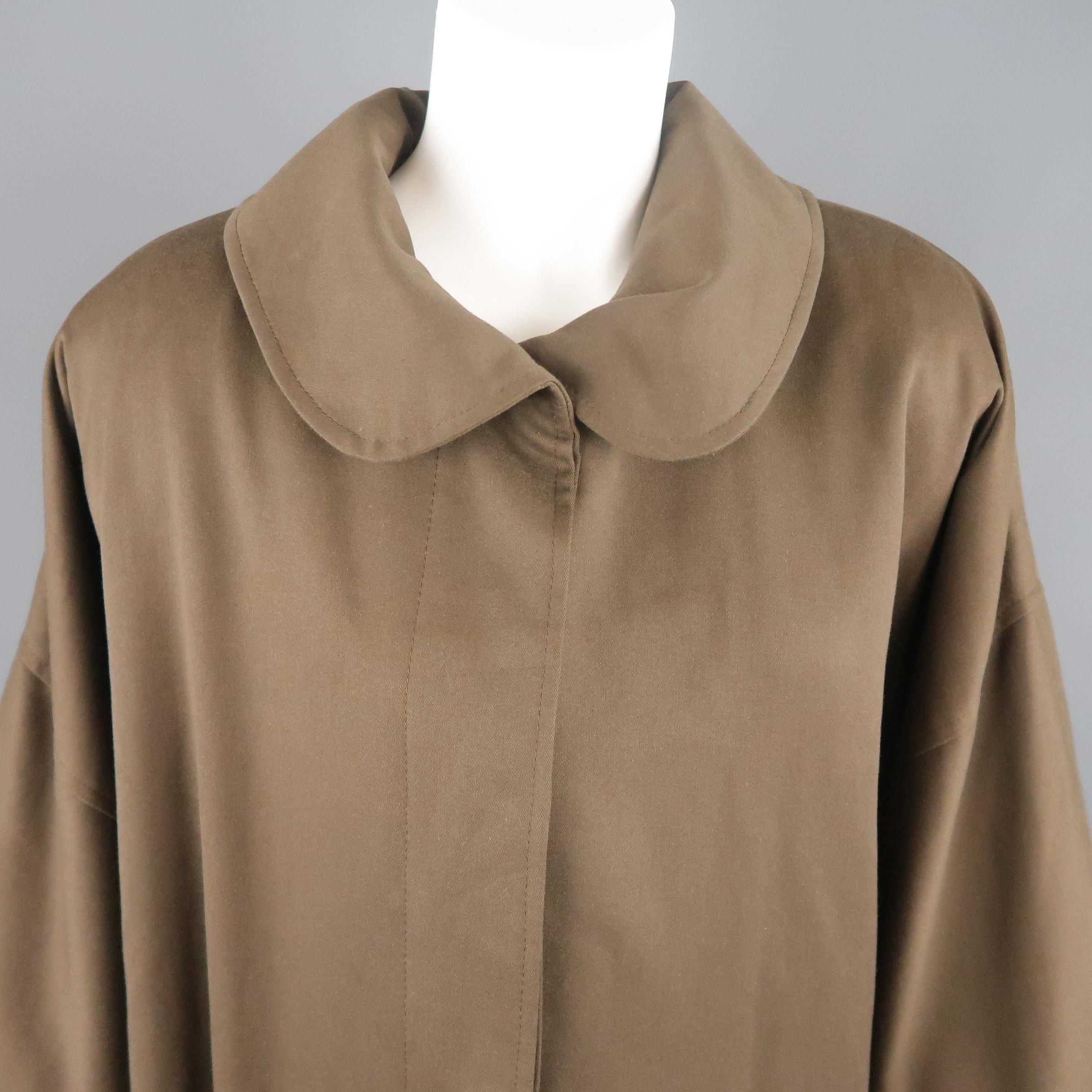 Vintage circa 1983 FENDI over coat comes in olive khaki gabardine with a padded drop shoulder, round collar, cuffed sleeves, Back belt, and hidden placket button front. Made in Italy.
 
Good Pre-Owned Condition.
Marked: (no size)
 
Measurements:
