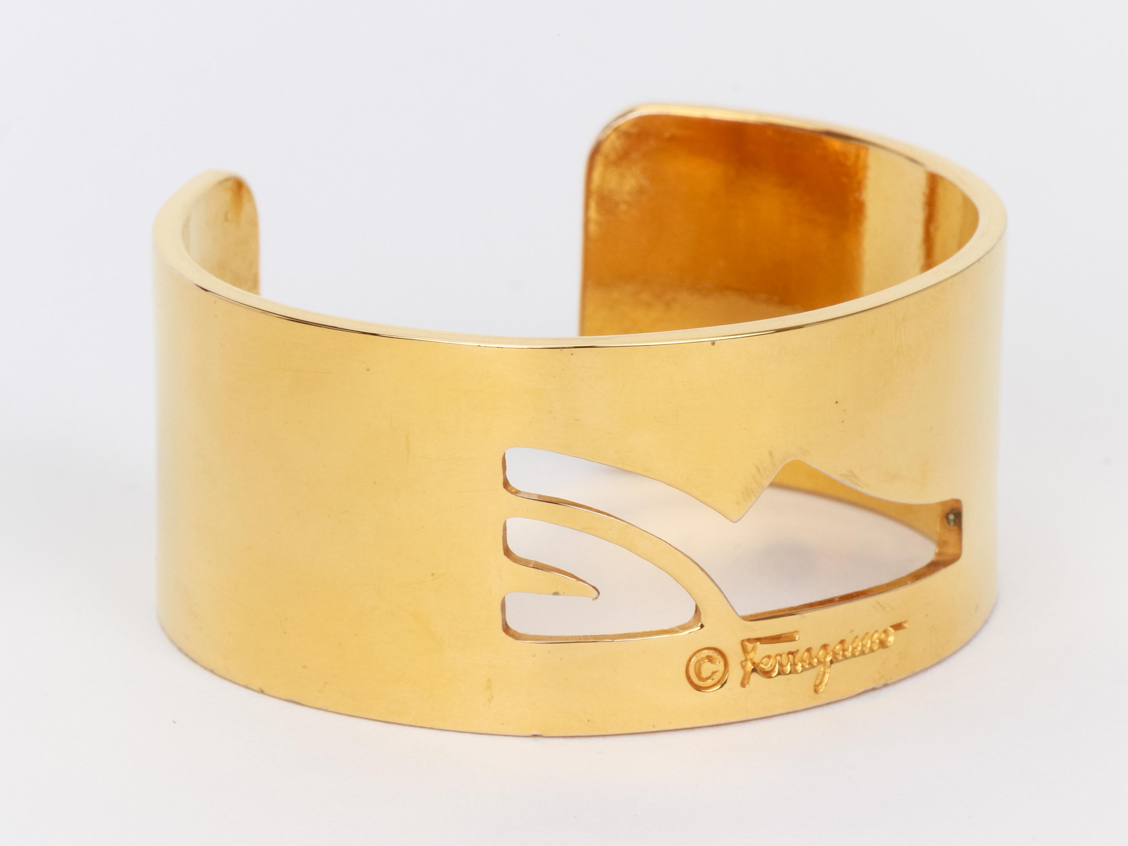 Ferragamo vintage gold tone cuff with cutout signature high heel shoe. Fits small and medium wrist, opening 1.1
