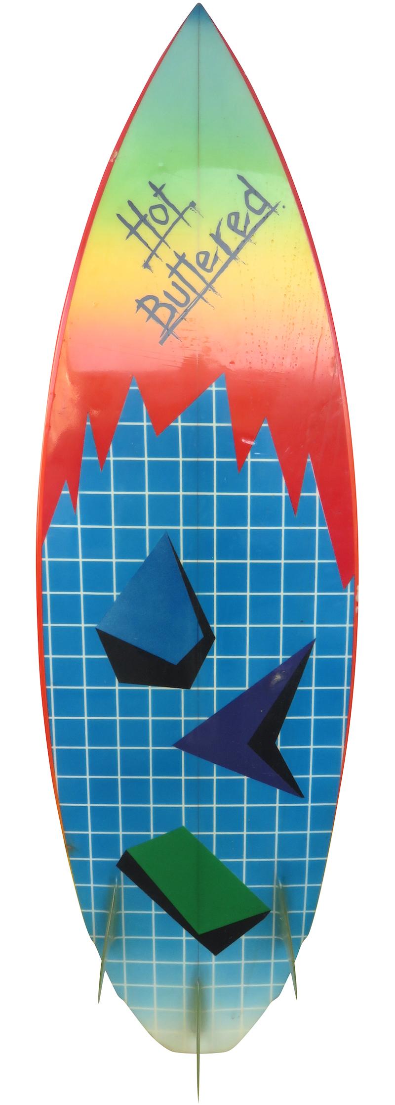 Early 1980s Hot Buttered thruster (tri-fin) shortboard surfboard shaped by Terry Fitzgerald in New Zealand. Features amazing retro airbrush designs on both sides of board with double winged swallow tail shape. A remarkable example of a colorful
