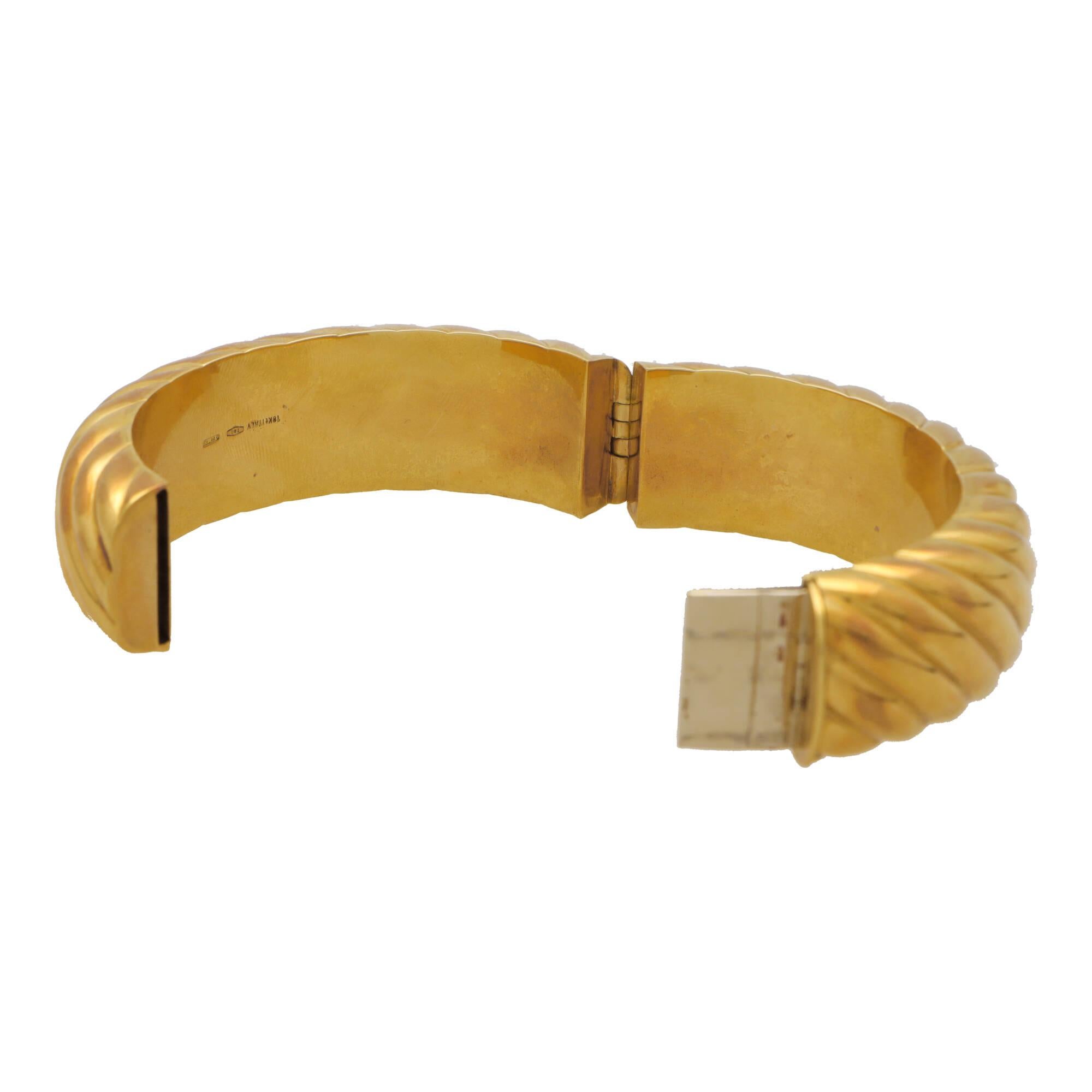 An extremely stylish vintage 1980’s Italian chunky hinged bangle set in 18k yellow gold.

The bangle is composed in an iconic 1980’s chunky design with ribbed detailing travelling throughout. The bangle is on a hinged fitting with a hidden push