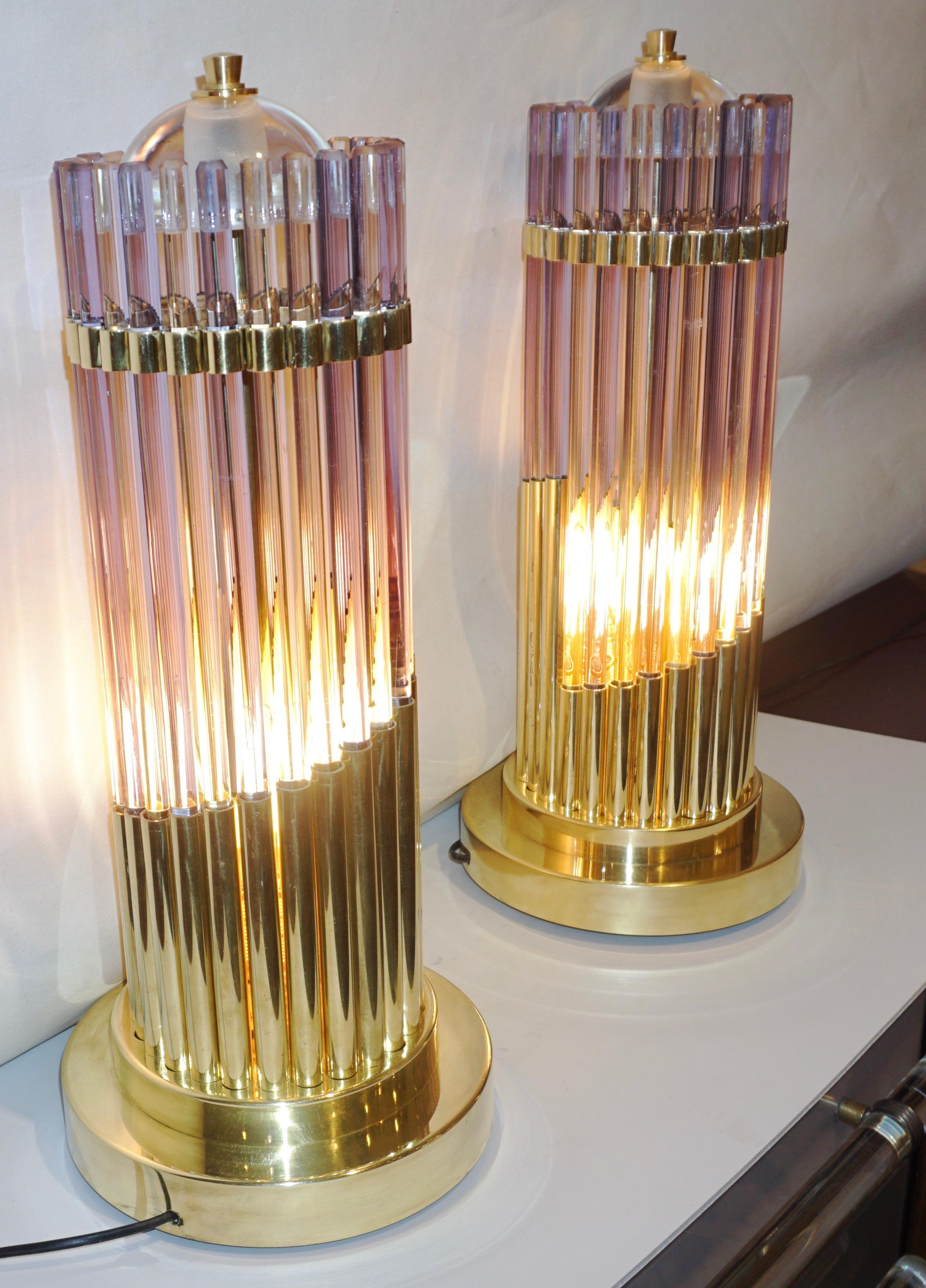 Early 1980s Italian pair of one of a kind table lamps, entirely handcrafted, exclusive modern design composed of handcut alexandrite Murano glass rods, individually set in handmade gradient brass cylindrical supports embracing the interior light