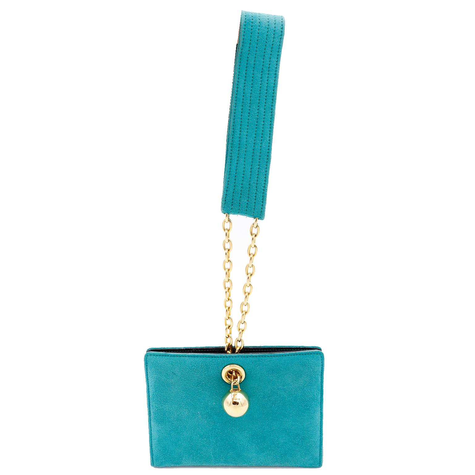 This fun 1980's vintage Jean Claude Jitrois green suede bag has a wrist loop handle that is attached to a gold link chain. The chain has chunky gold balls on the end, making it almost like a piece of jewelry! There are 2 inner snaps for closure and